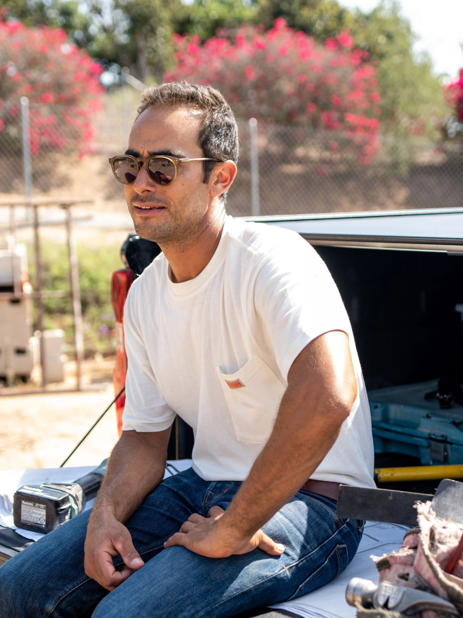 man sitting on back of truck
