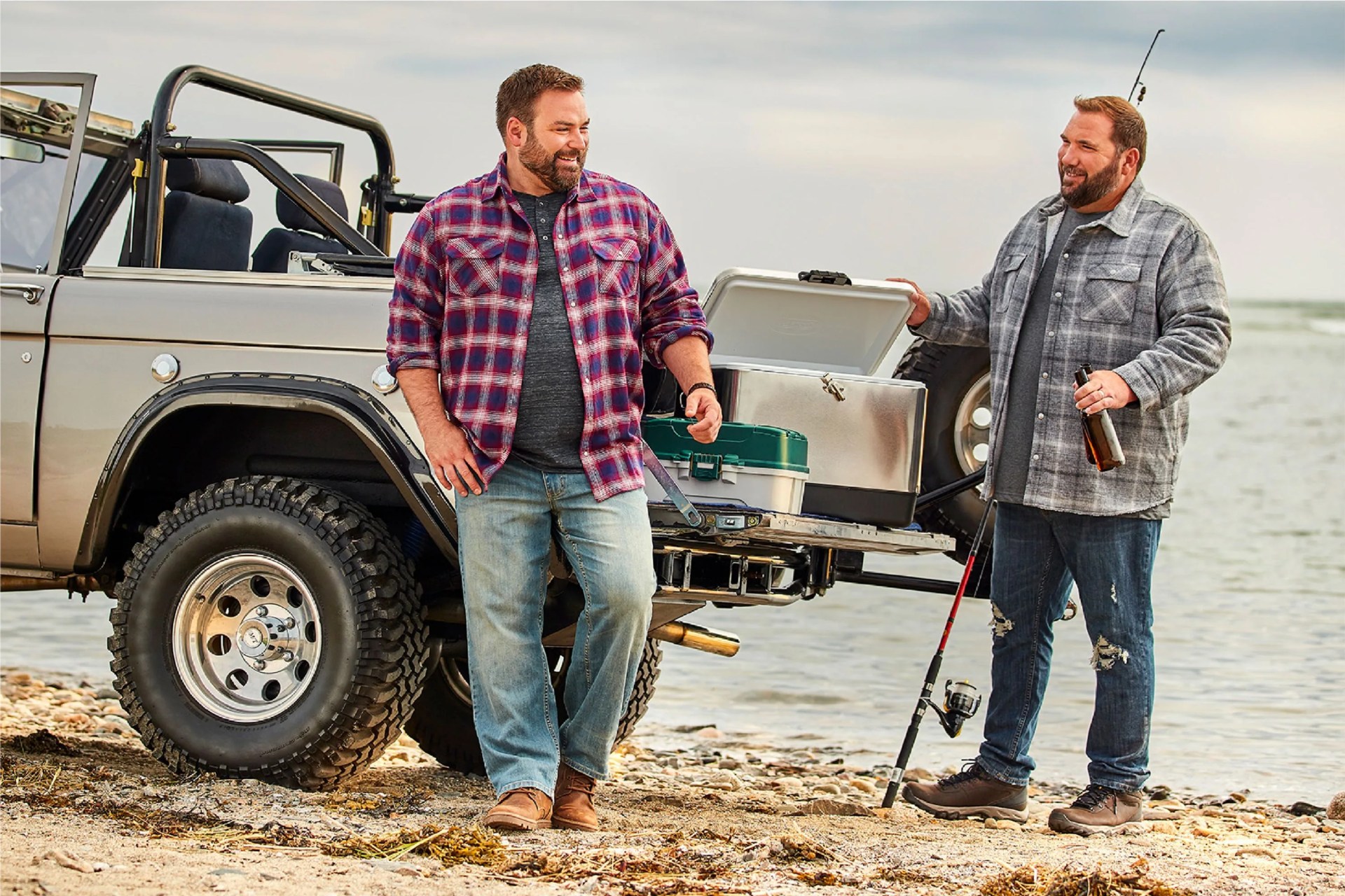 two men wearing destination xl jeans by a lake