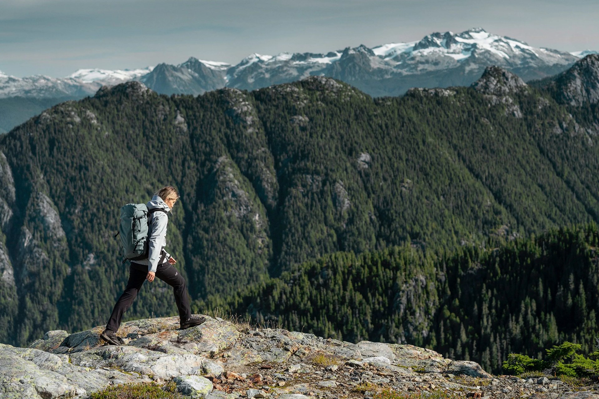 man hiking in mountains wearing arc'teryx gear