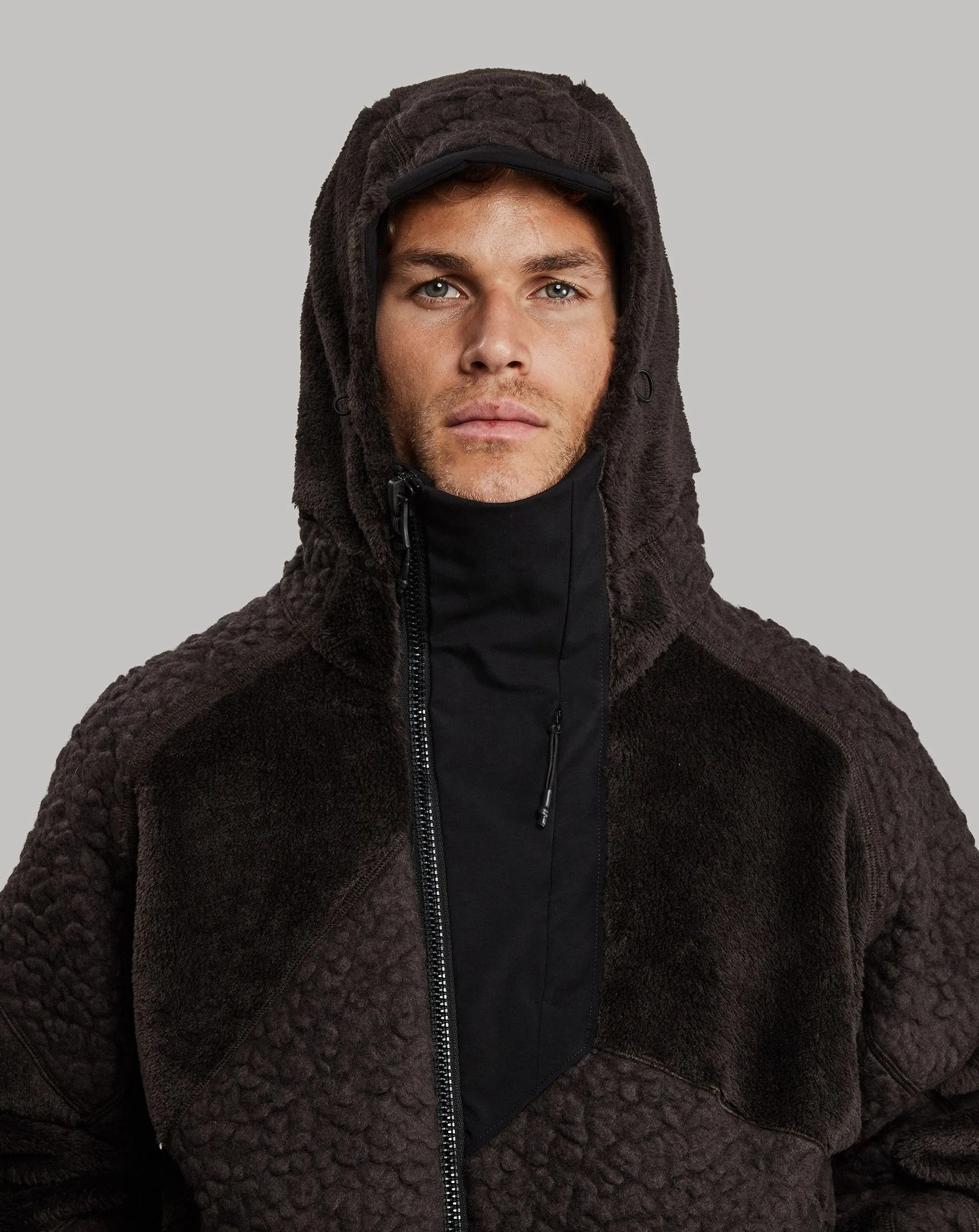 man wearing vollebak nomad hoodie dark edition