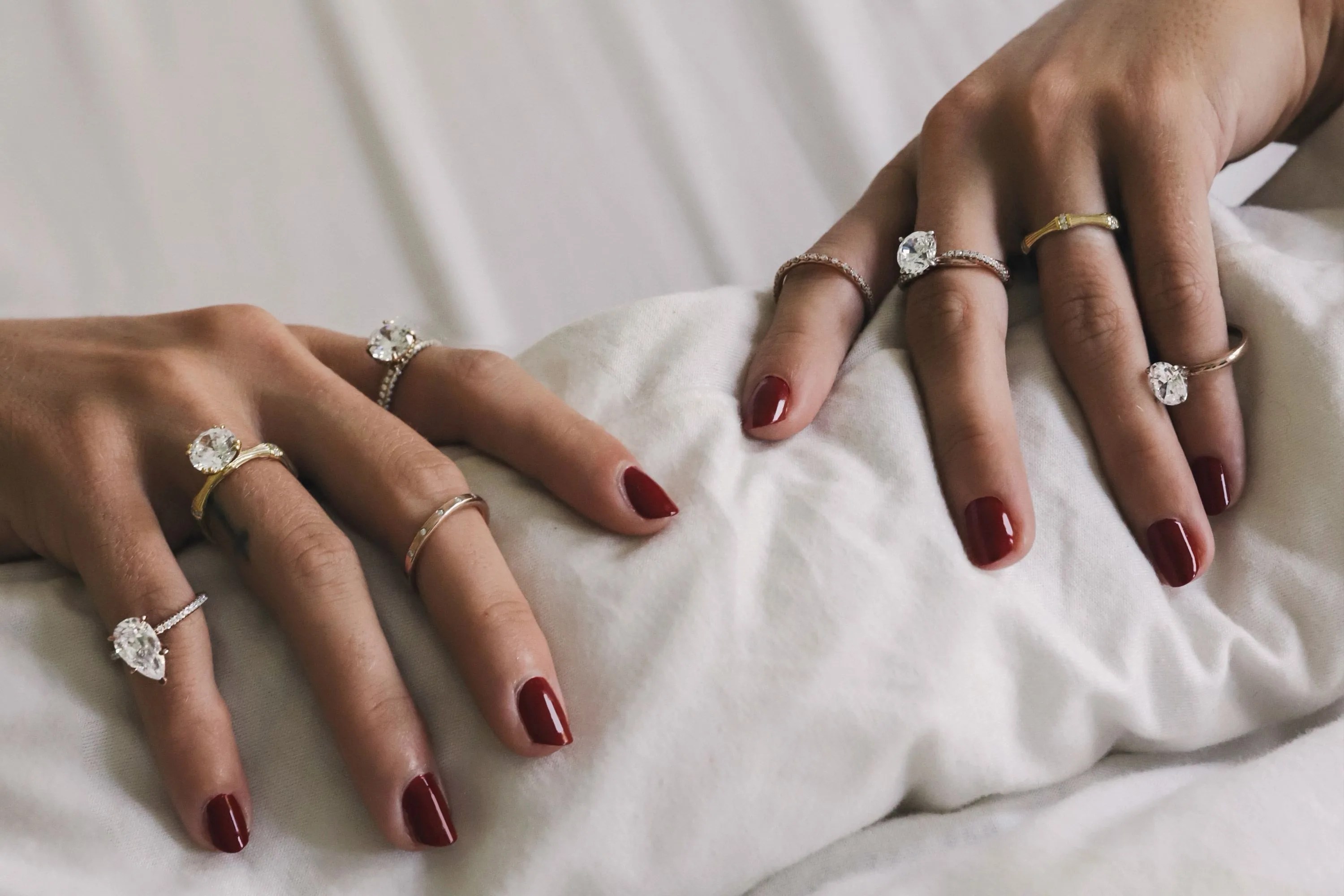 two hands wearing rings