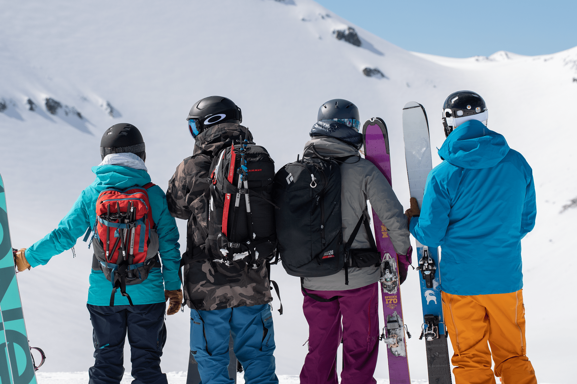 snowboarders on snowy mountain with backcountry gear
