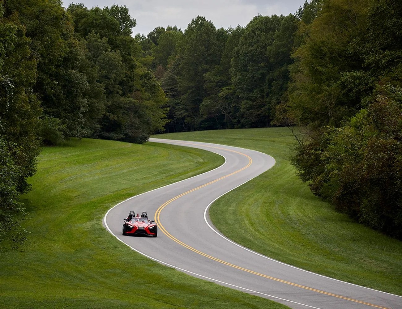 2021 polaris slingshot red car driving