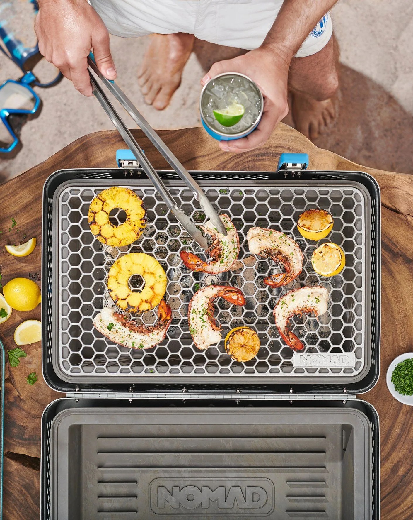 man grilling with nomad tools