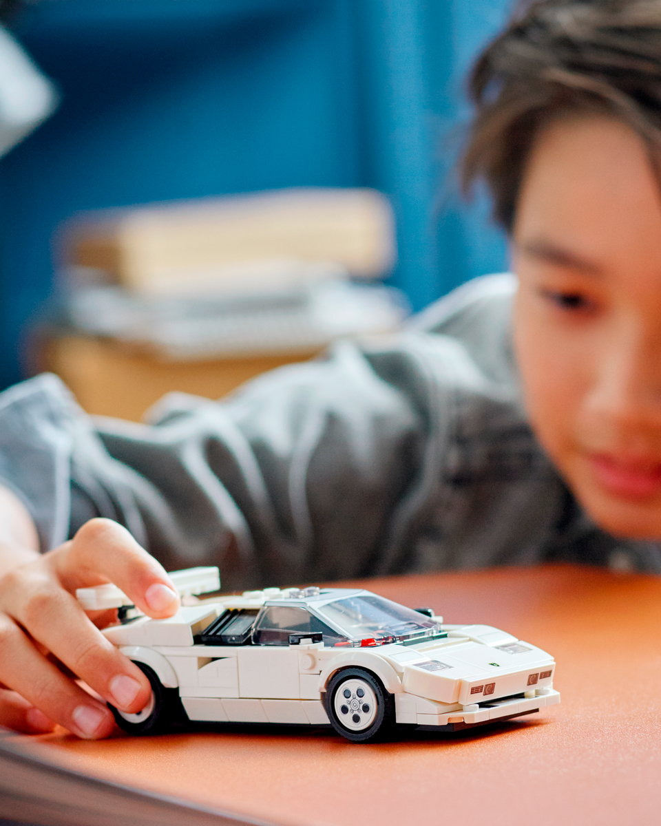 kid playing with lego lamborghini countach