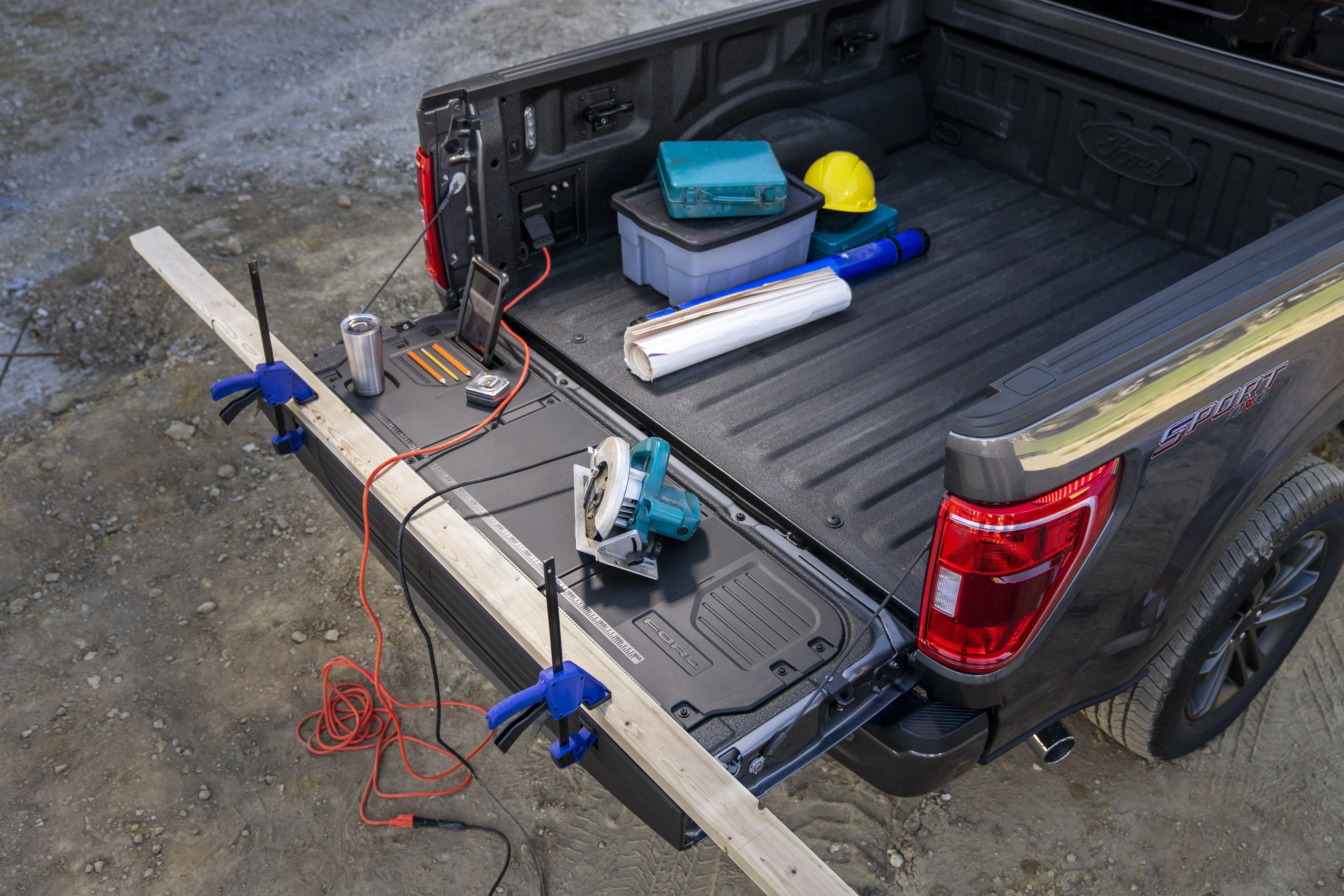 all new f 150 with available pro power onboard, standard clamp pockets so customers can hold materials down for precision work, standard cleats mounted to the sides of the tailgate to act as tie down locations for extra long items in the bed and available tailgate work surface including integrated rulers, a mobile device holder, cupholder and pencil holder