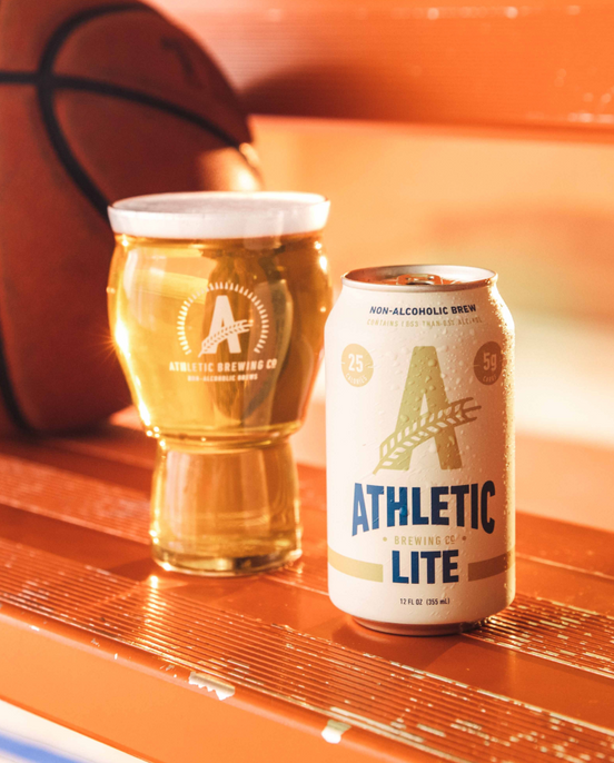 athletic lite beer on bench next to basketball