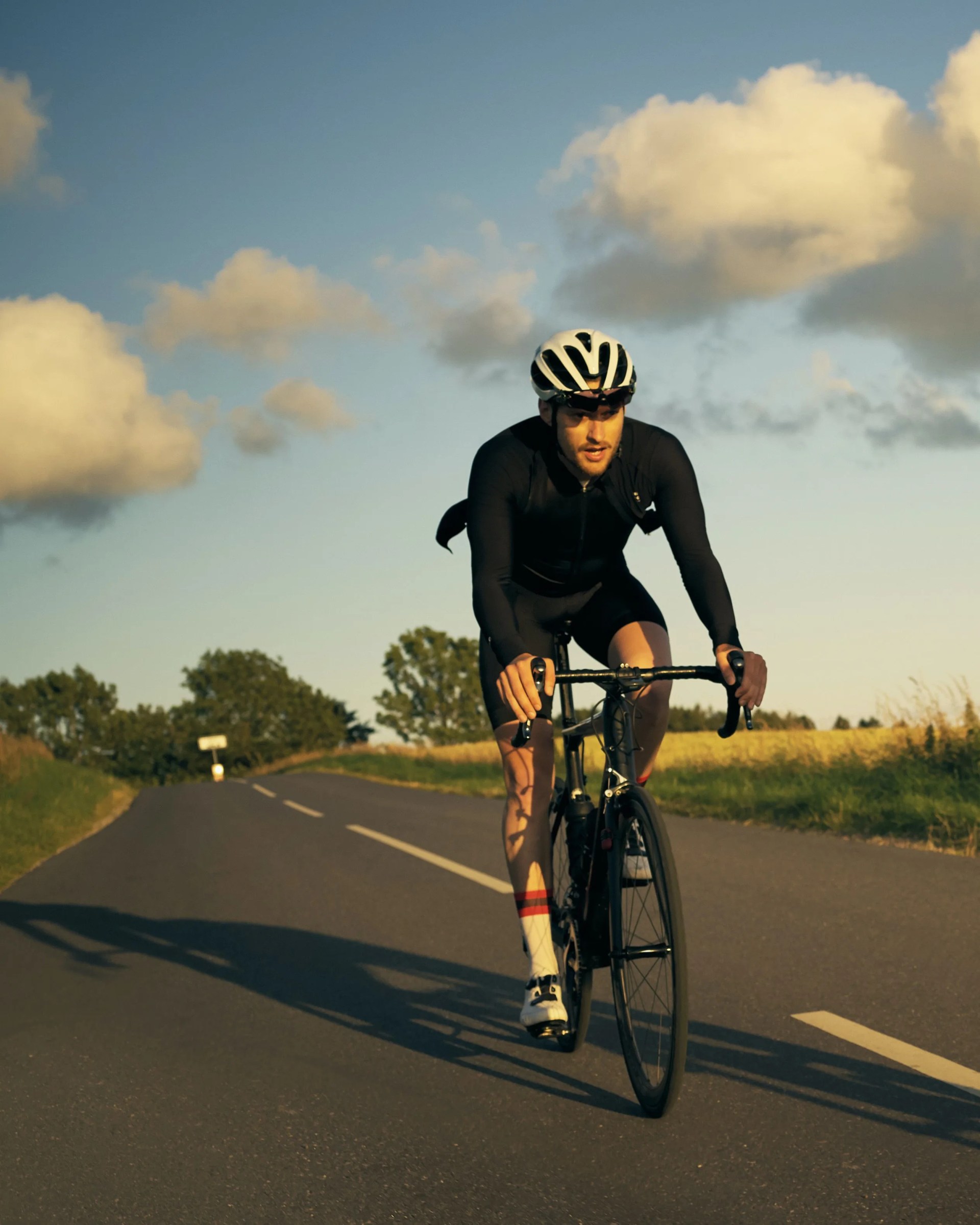shot of two cyclists out cycling on a country road
