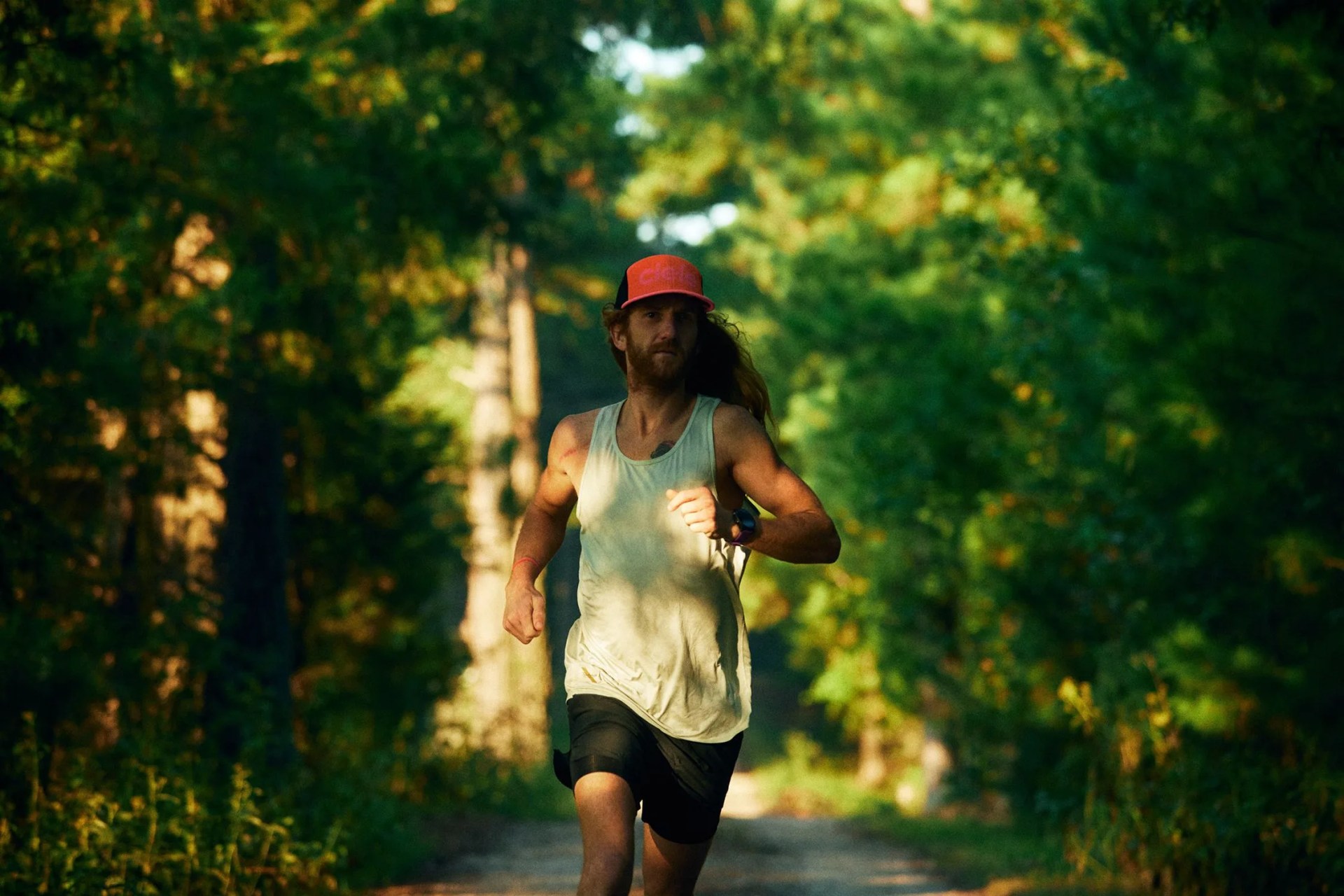 man running wearing ciele athletics hat