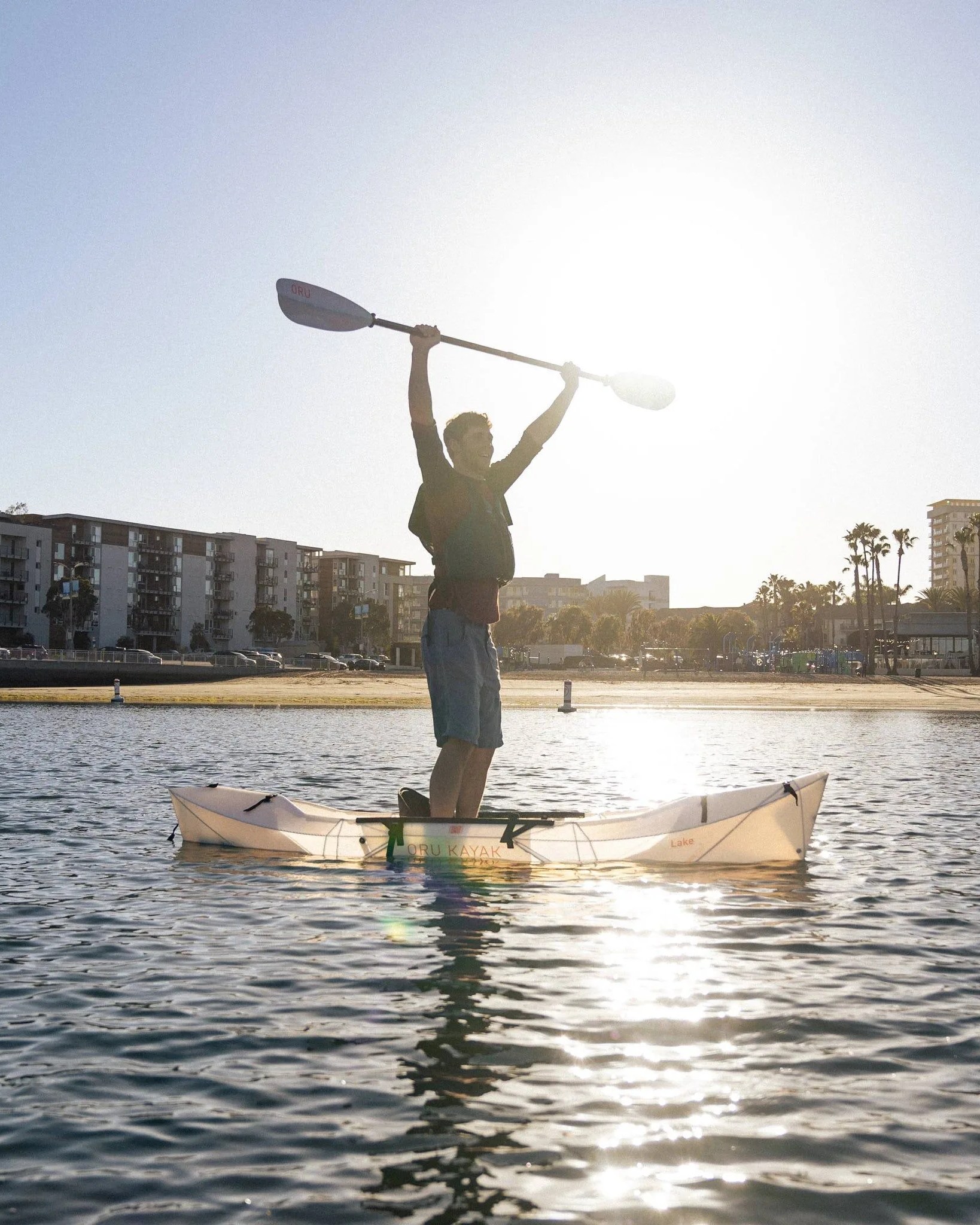 man posing on the lake world's lightest foldable kayak