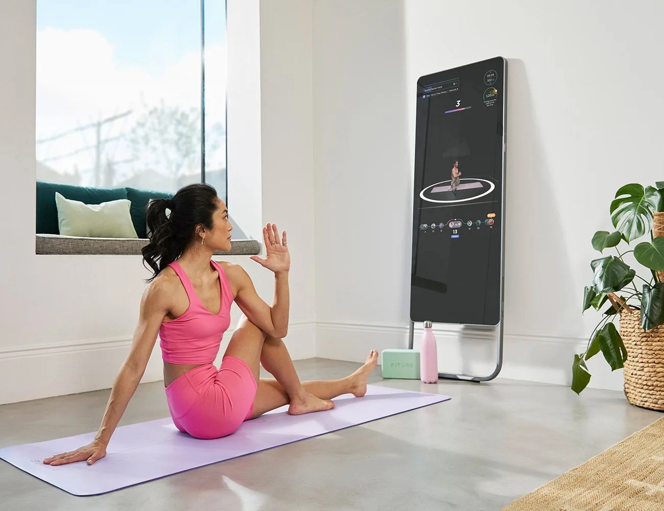 a couple using fiture interactive smart fitness mirror