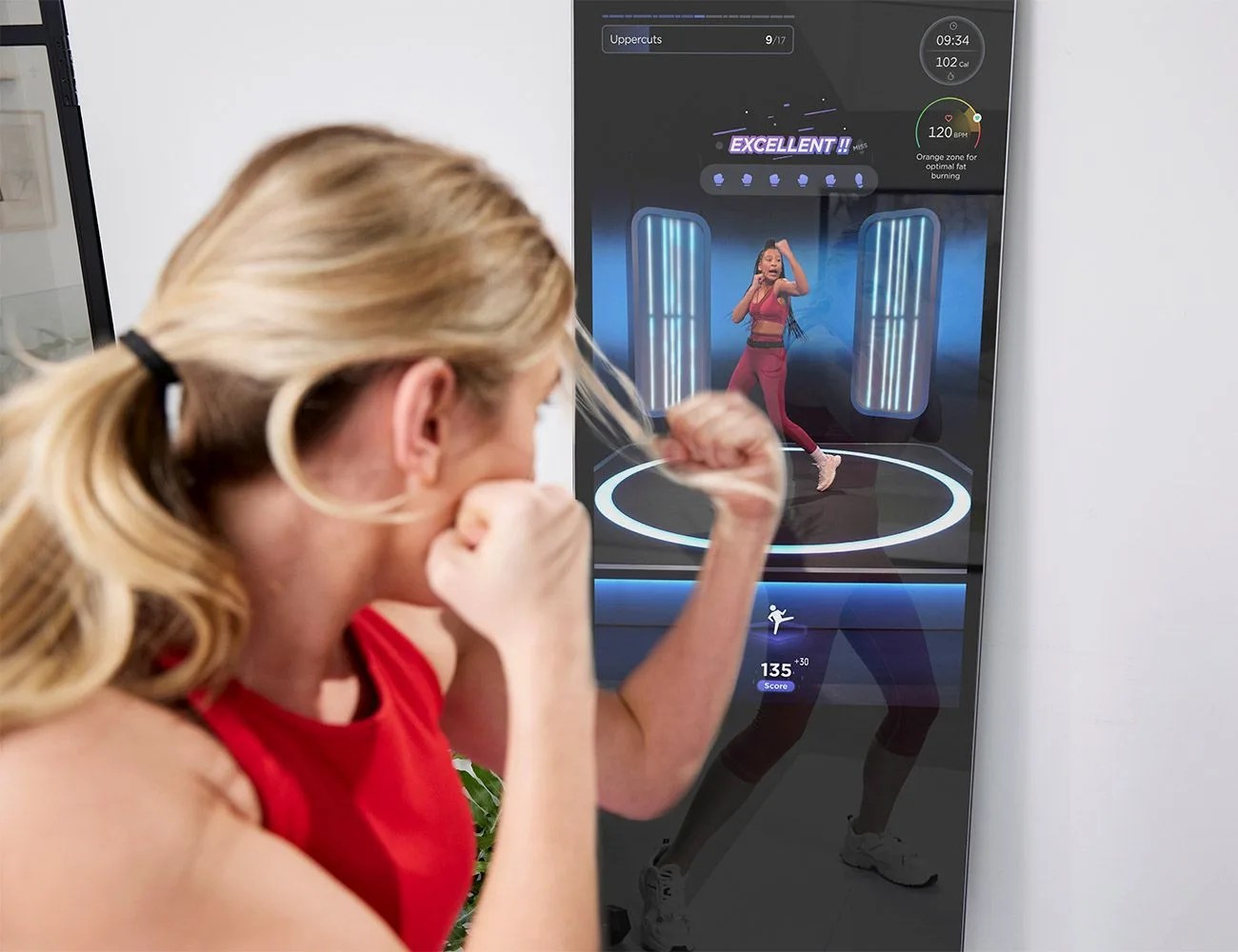 woman using fiture interactive smart fitness mirror