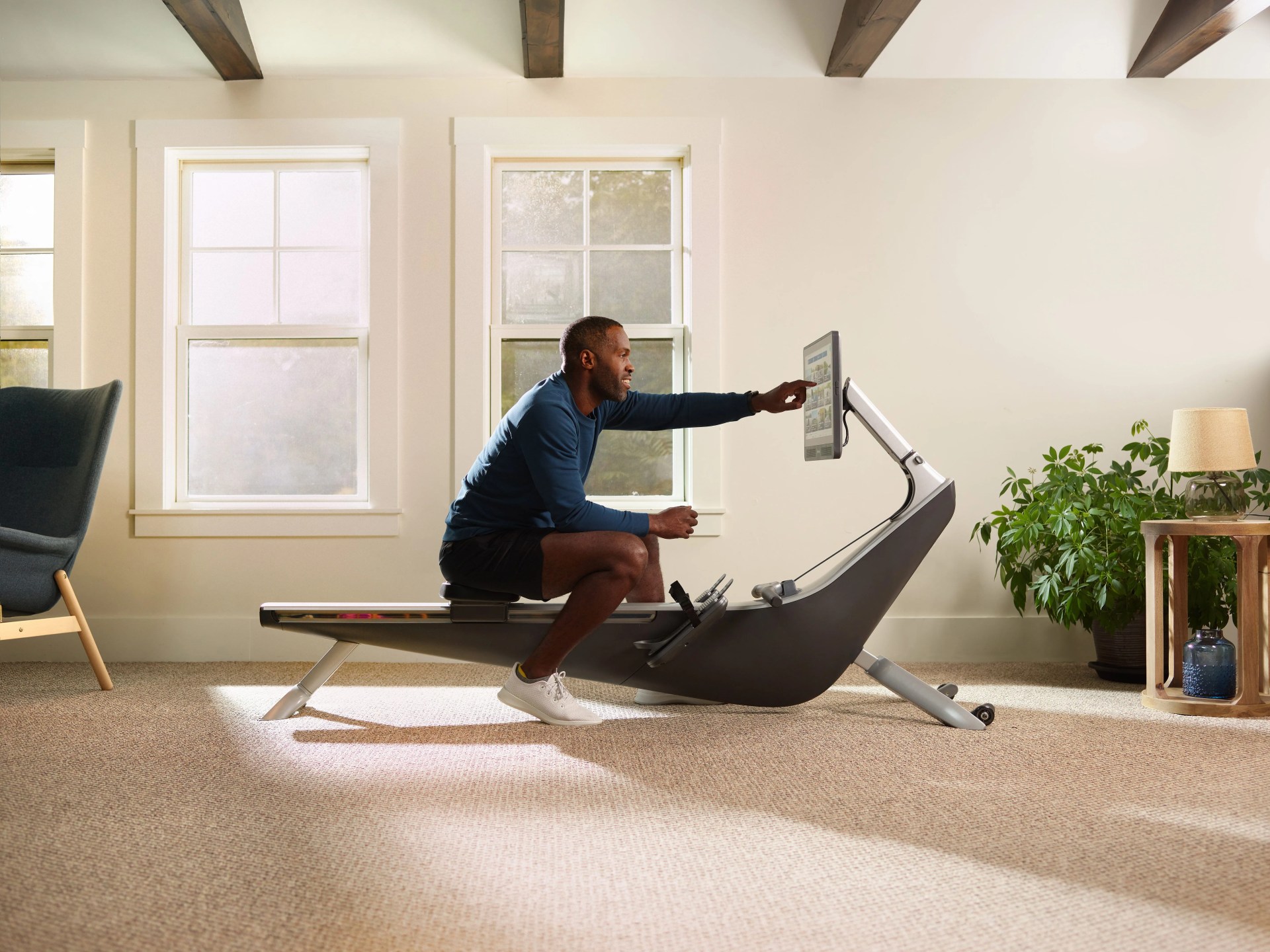 man using hydrow exercise machine