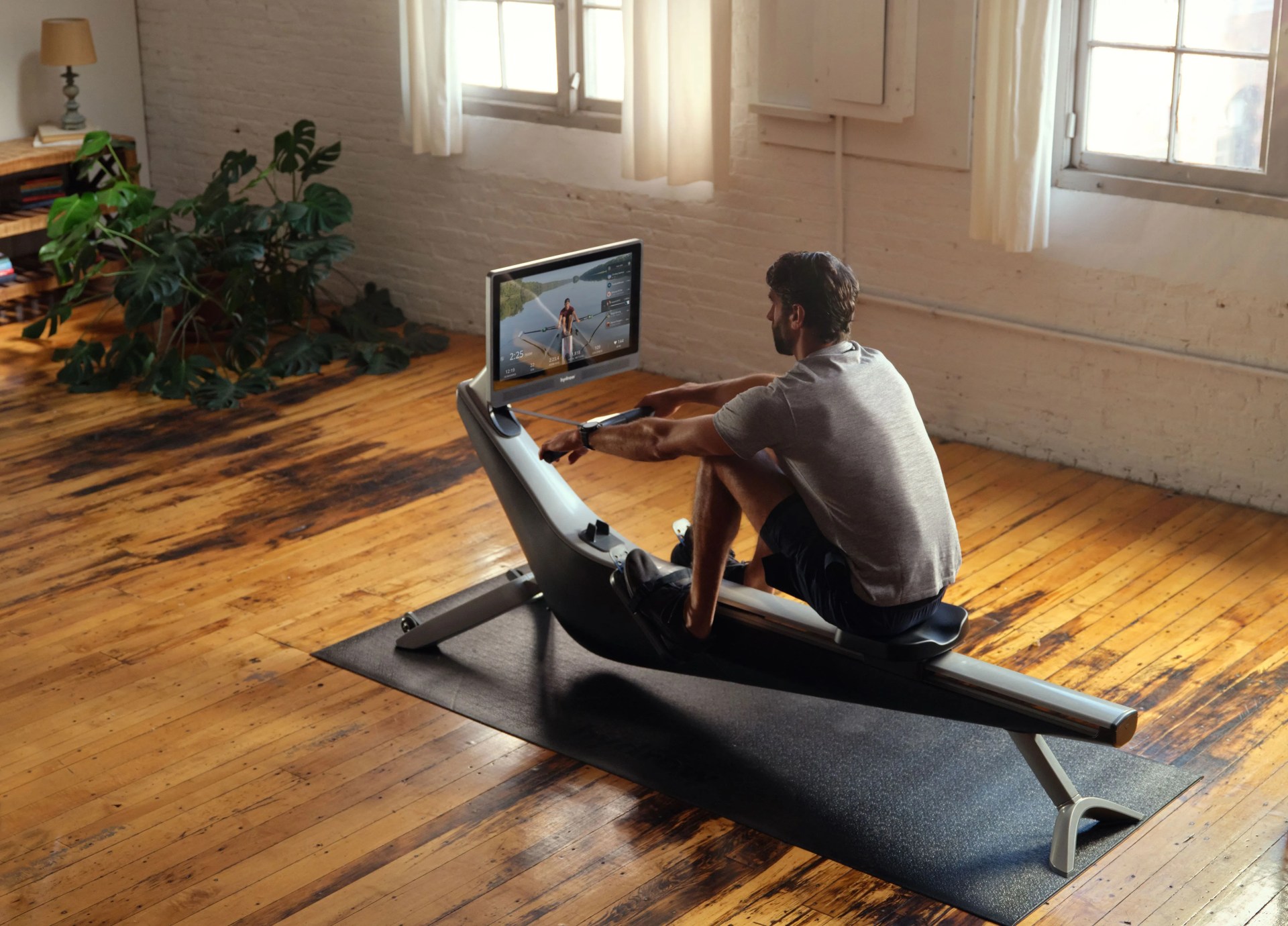 man rowing on hydrow machine