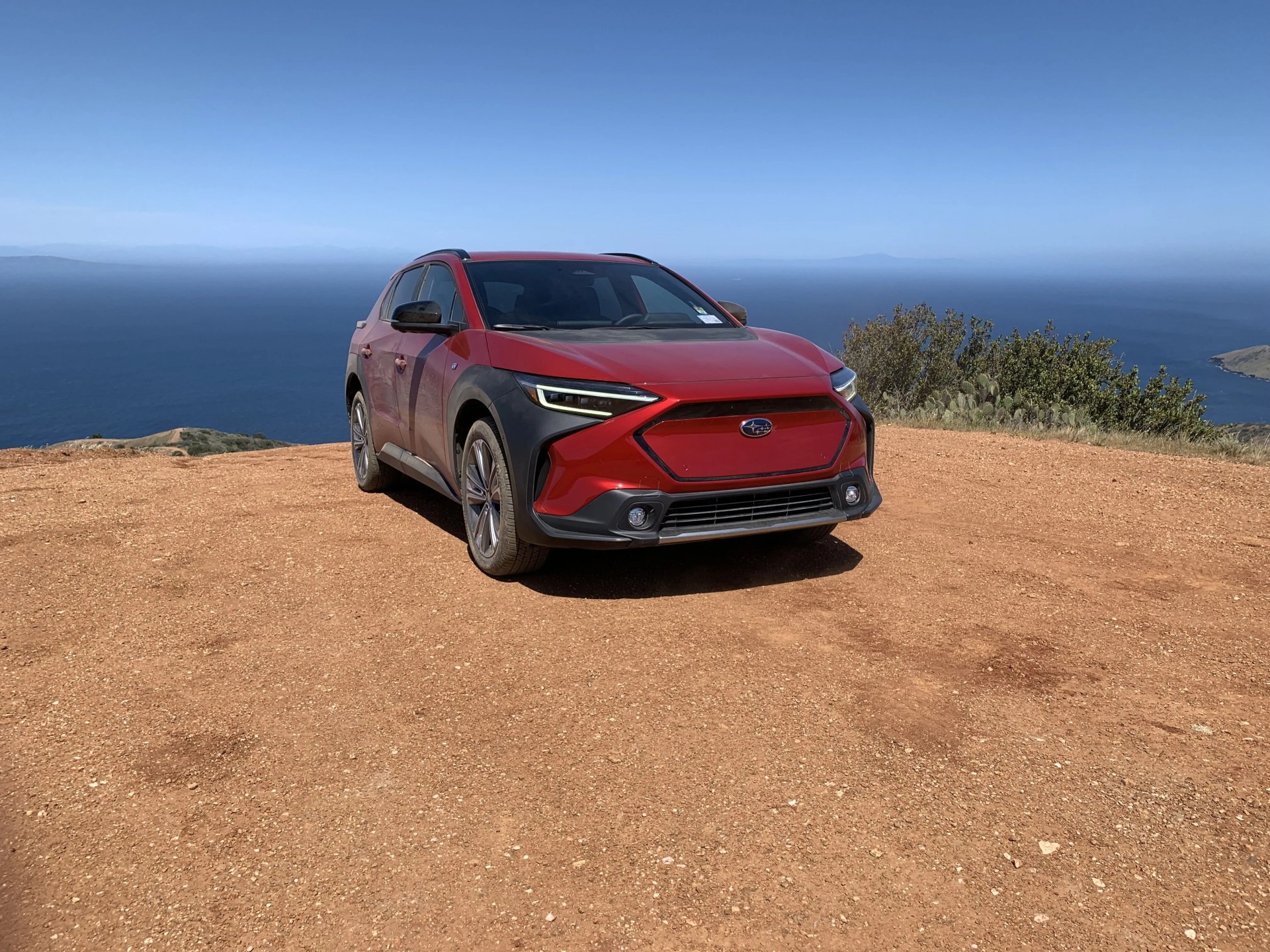 subaru solterra on a mountain top overlooking the ocean