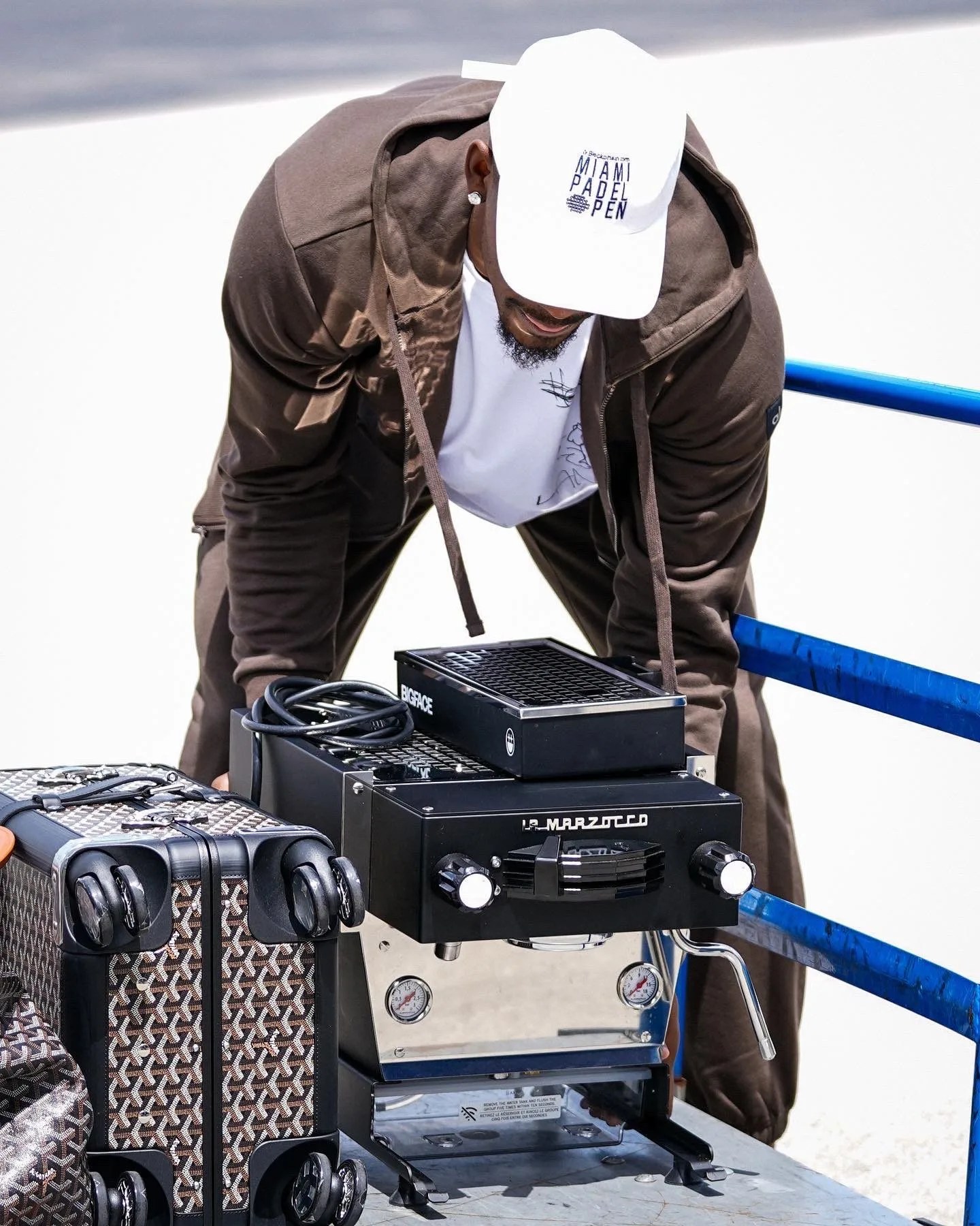 man loading espresso machine onto a cart