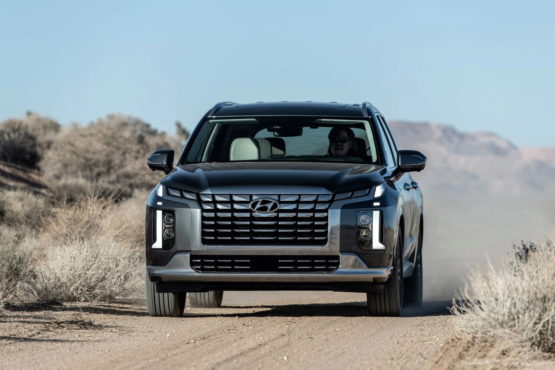 frontal shot of the new hyundai palisade driving over dirt
