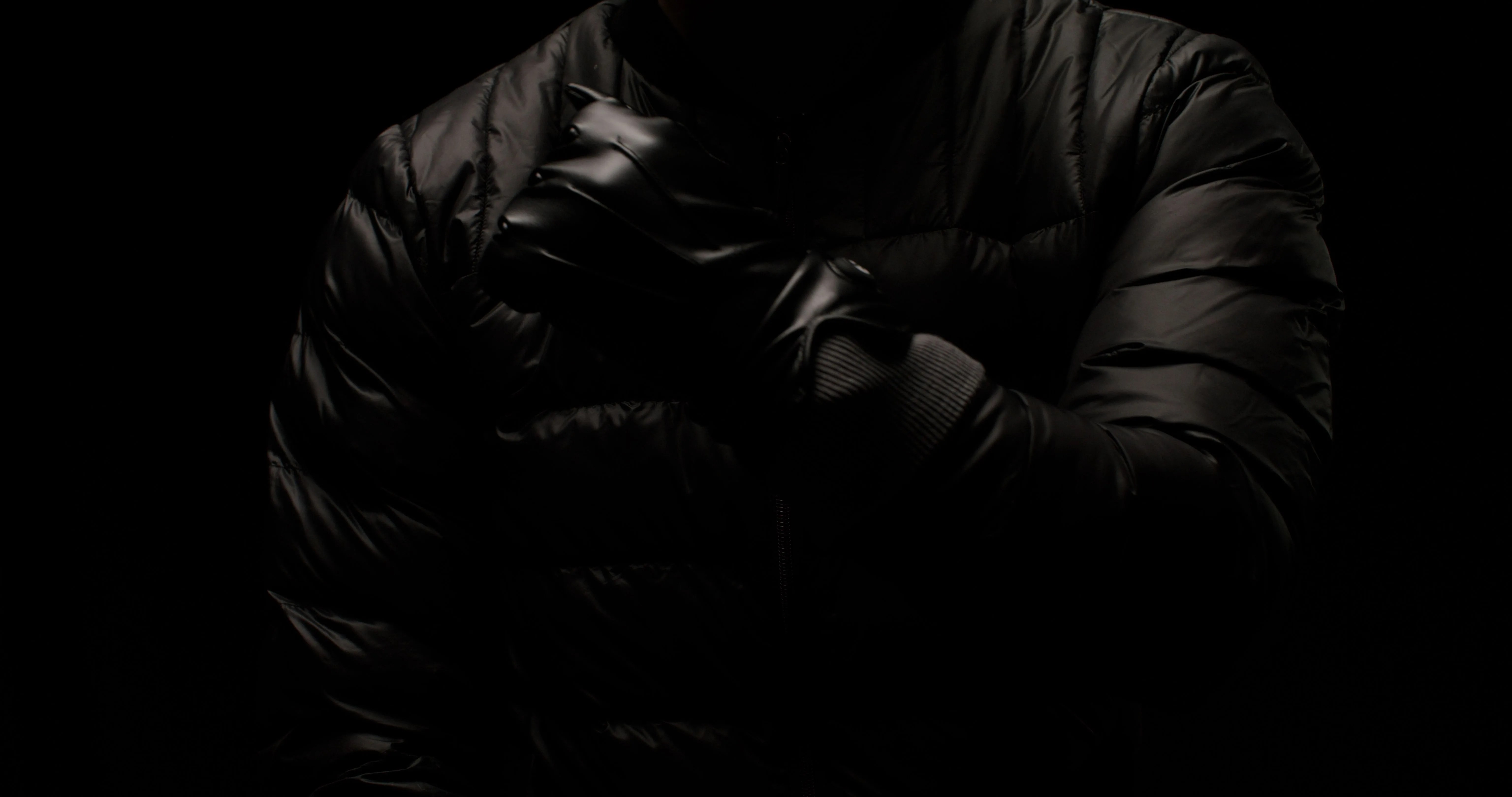 person holding one arm across chest wearing quanta vici jacket