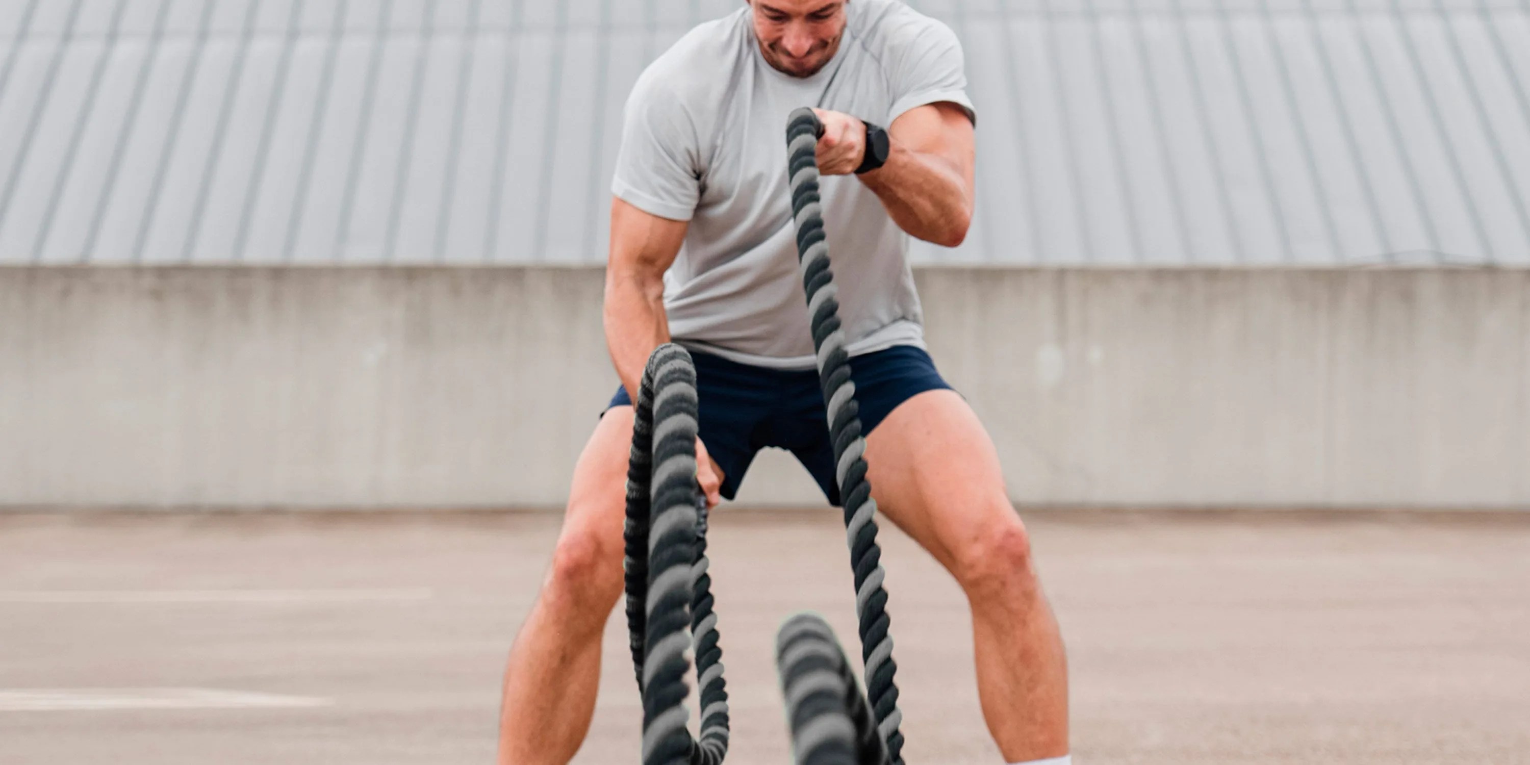 athlete performing battle ropes wearing ten thousand seamless shirt