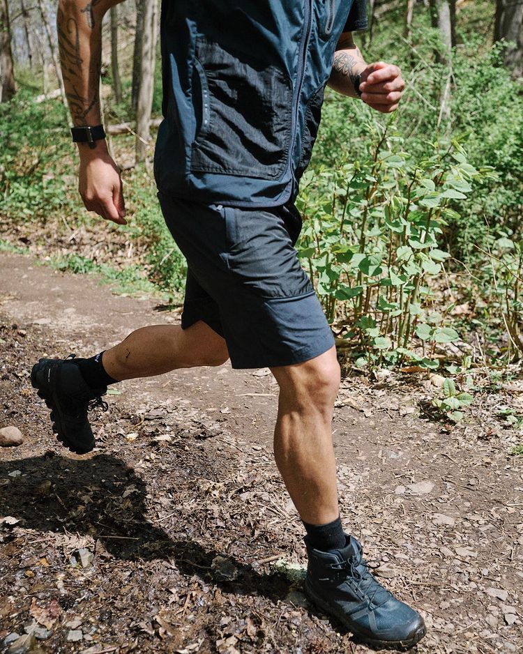 man running on trail wearing brady trail short