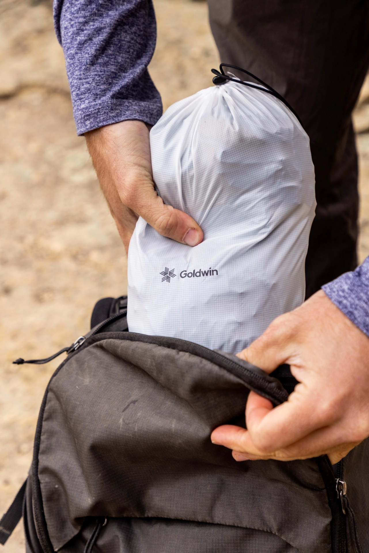andy cochrane pulling goldwin bag out of backpack
