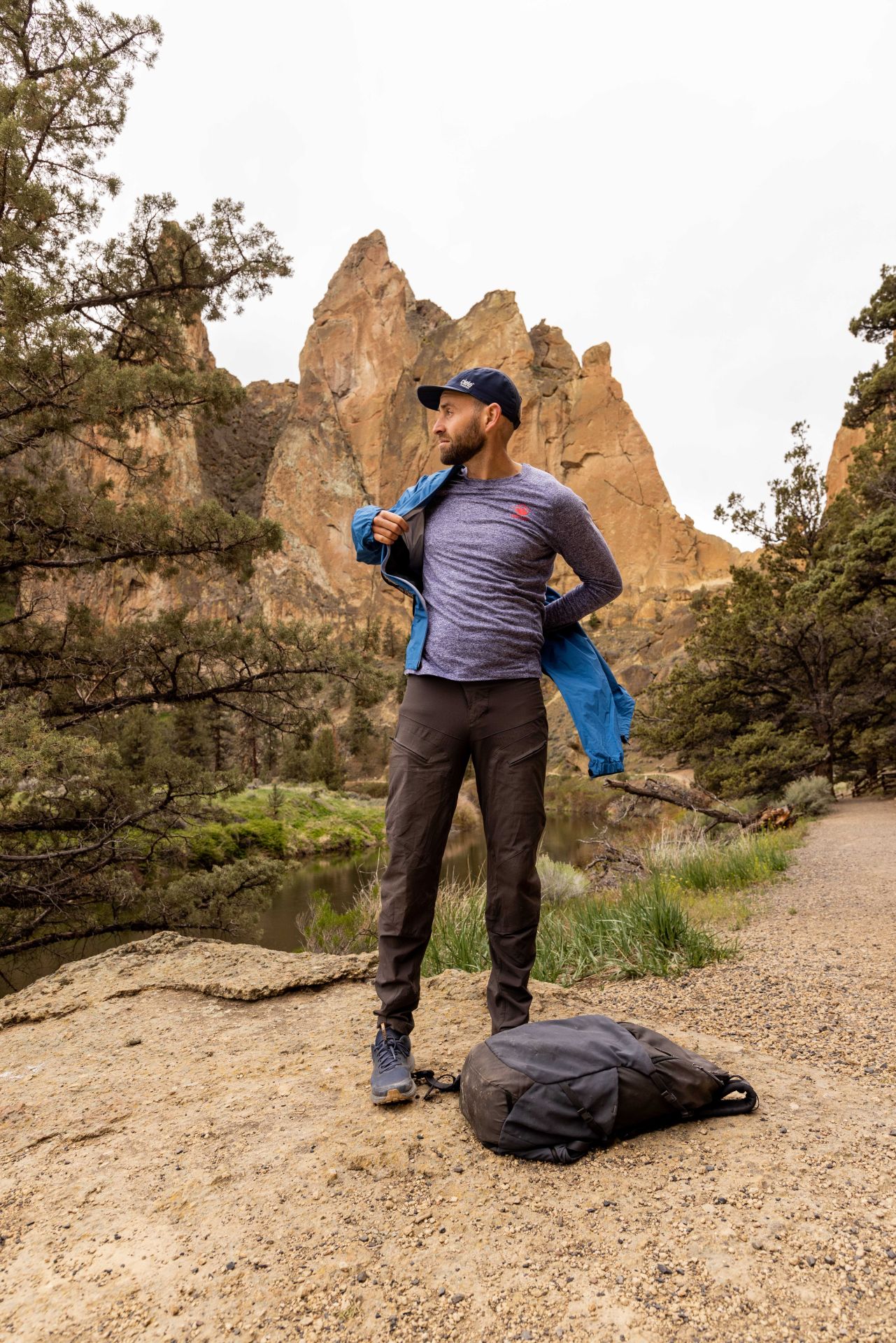 andy cochrane putting on goldwin jacket while looking out at scenery