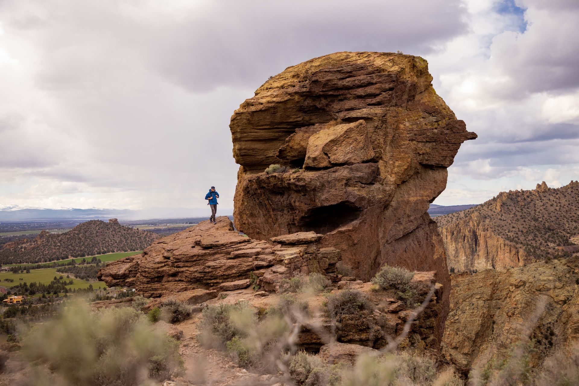 andy cochrane standing next to giant rock formation