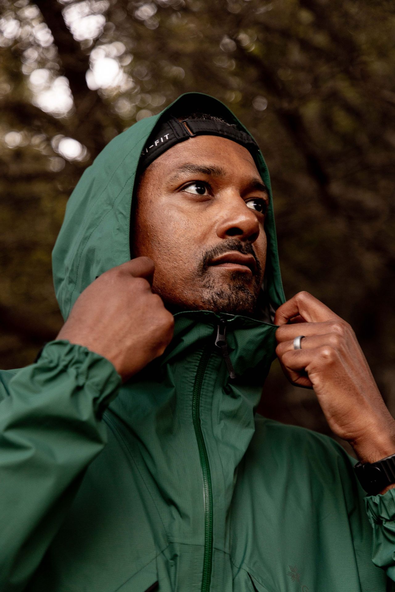 dezmond taylor douglas pulling up collar of goldwin jacket with hood up