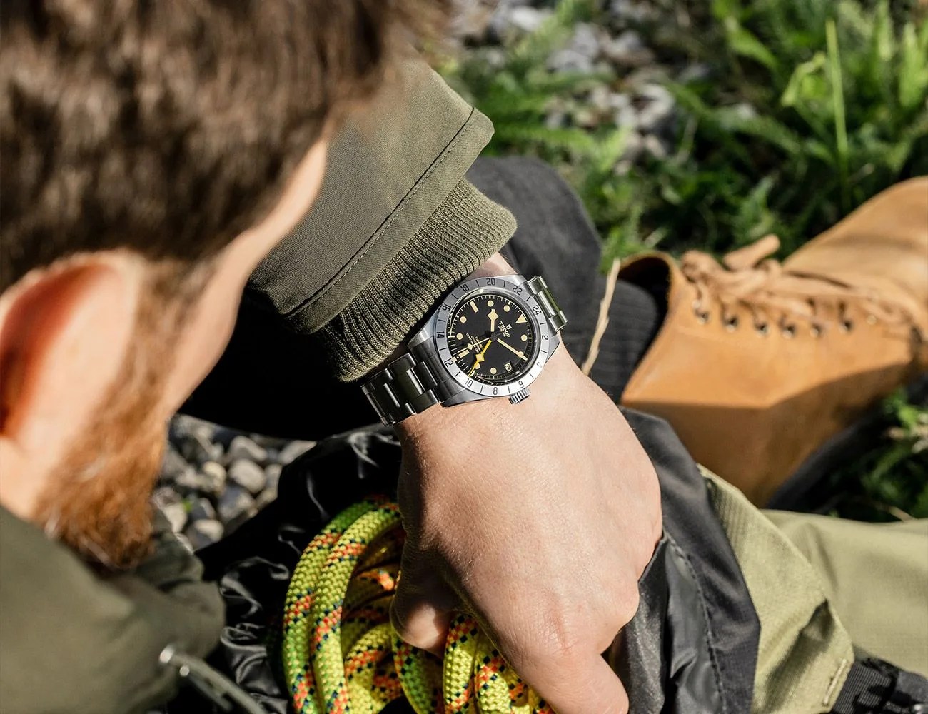 man looking down at tudor black bay pro