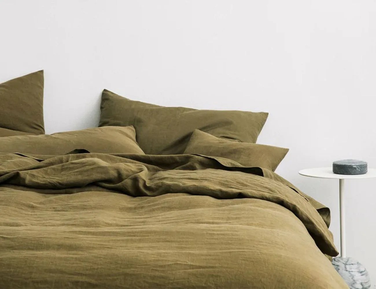 green duvet cover on a bed