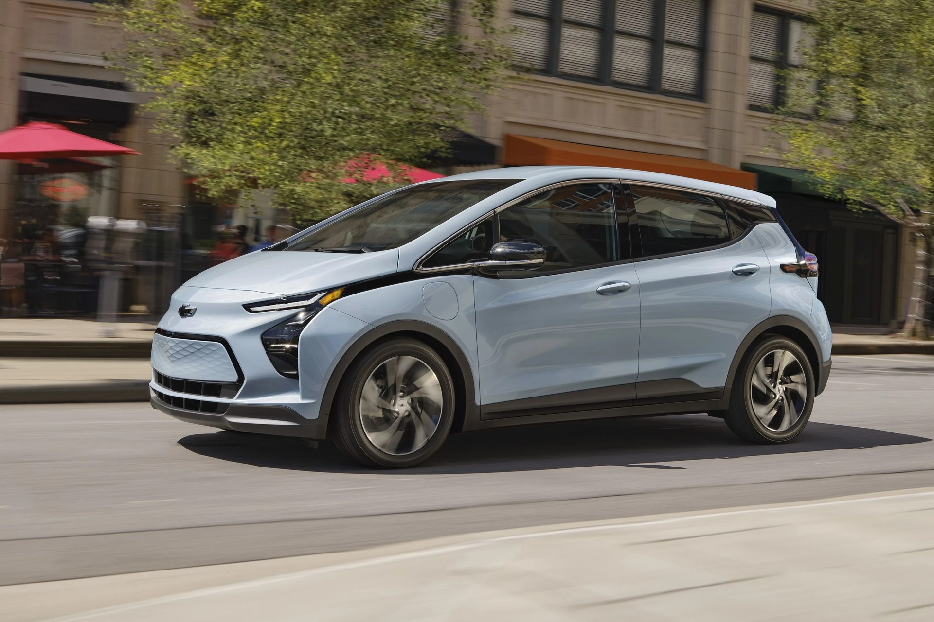 2023 bolt ev side profile while driving on an urban city street