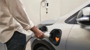 man charging a chevrolet bolt ev car