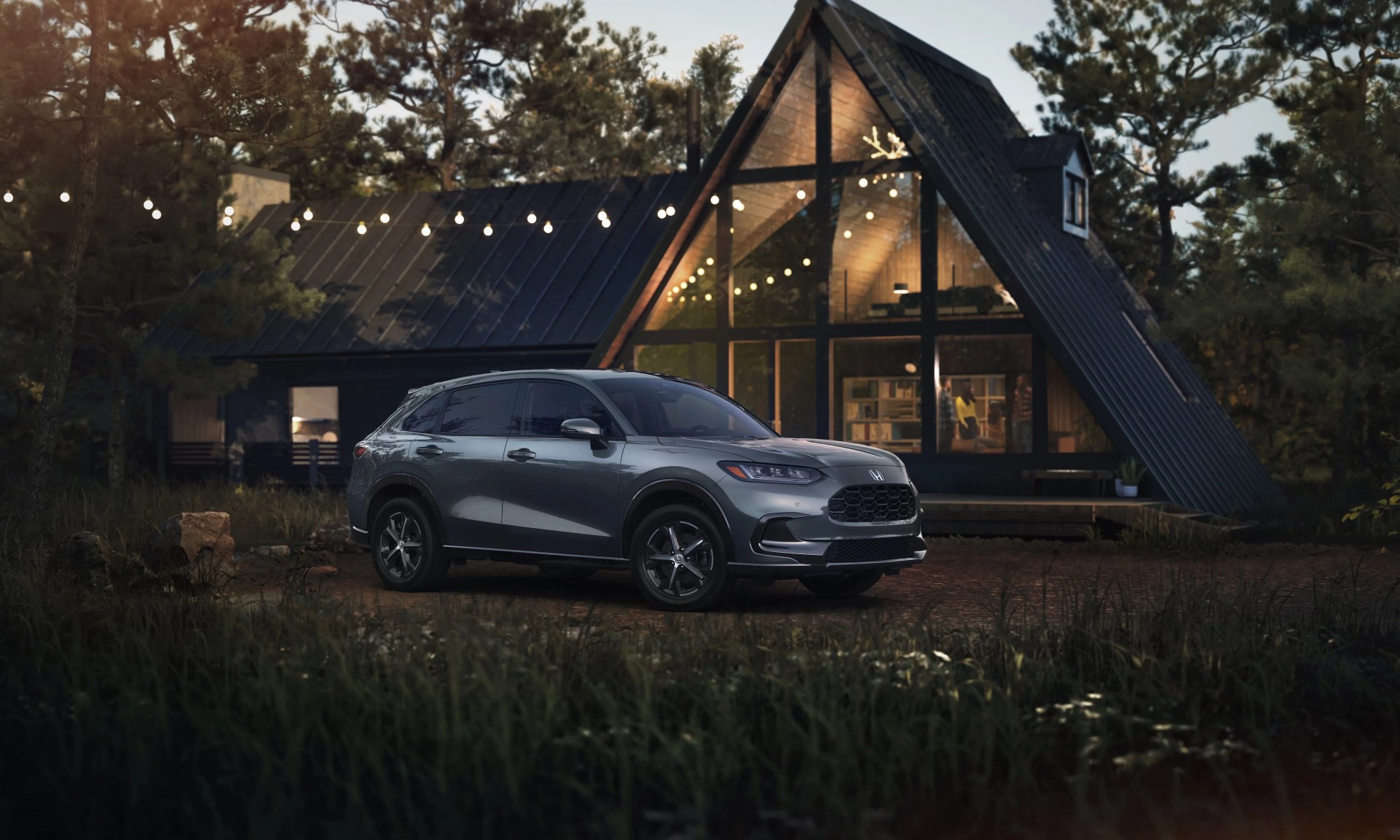 2023 honda hr v ex l parked in front of a fancy wood and glass home in the woods