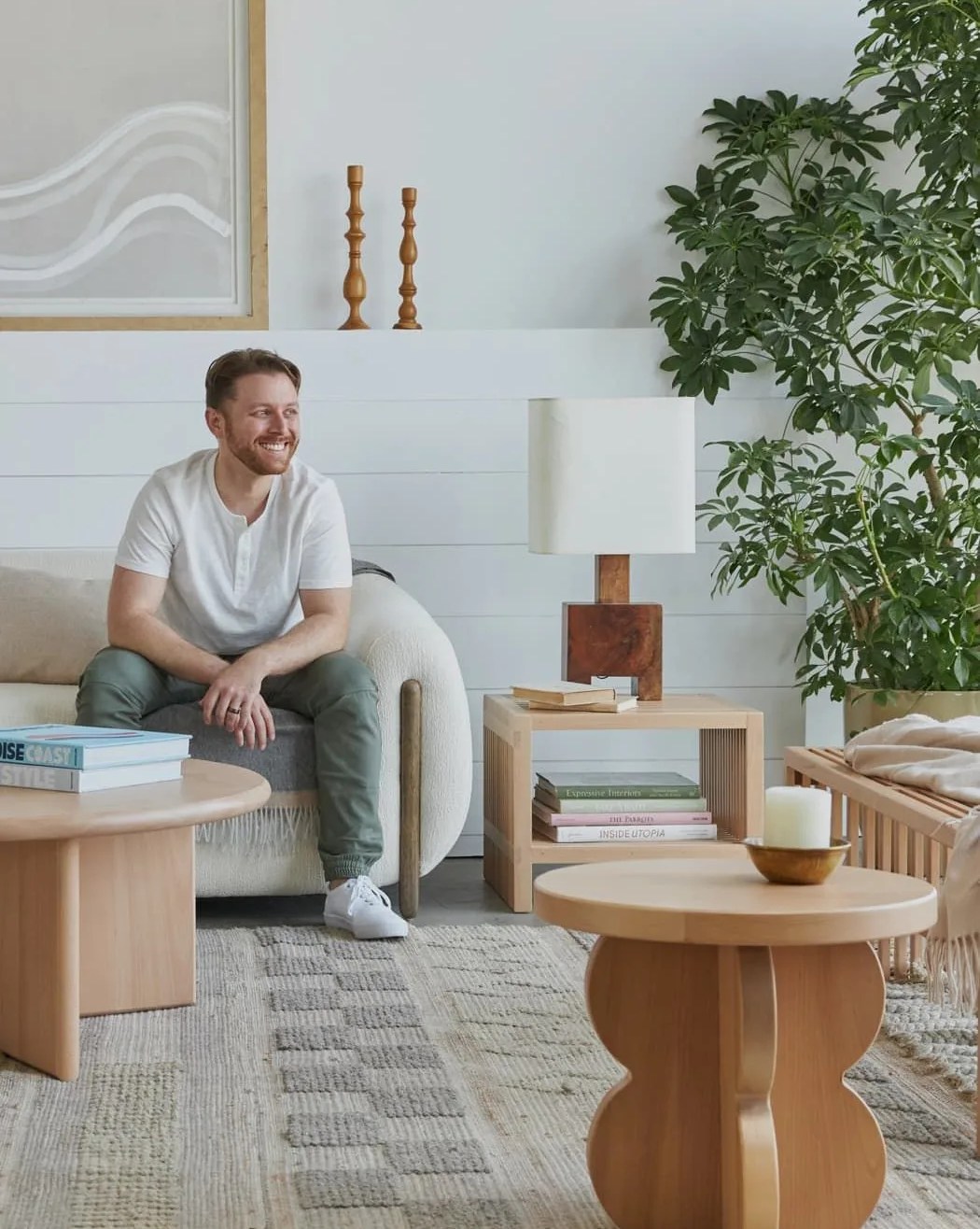 man sitting on couch next to avocado solid wood furniture