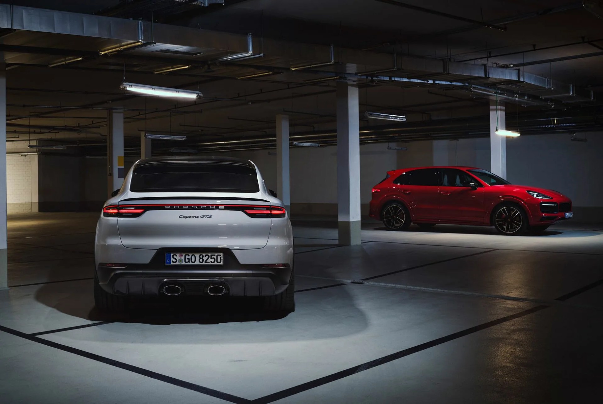 porsche cayenne gts shot from the rear parked in a dark parking garage