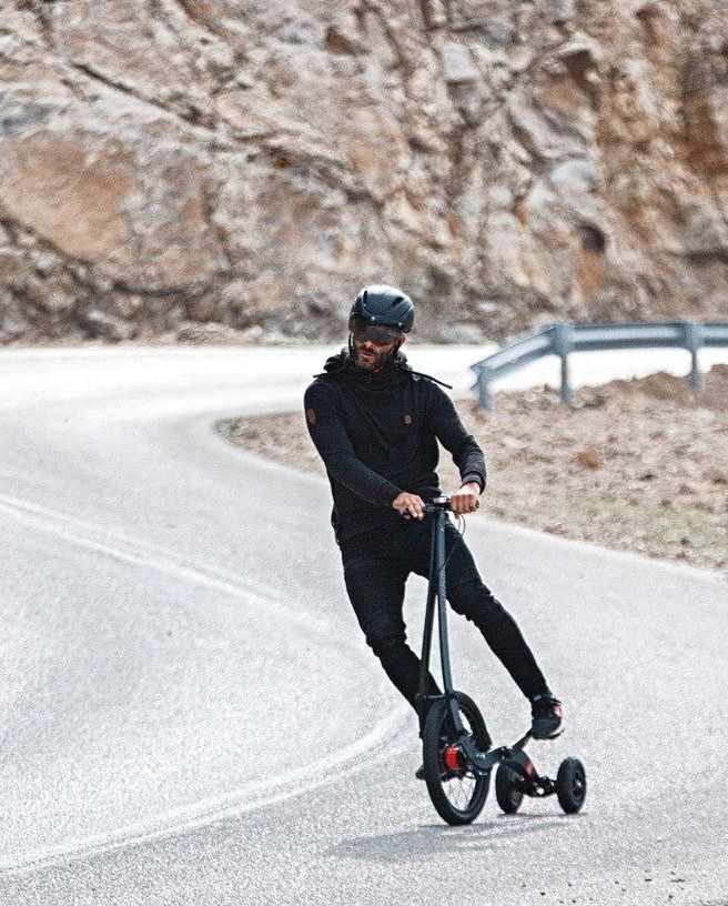 man riding halfbike 3 down hill