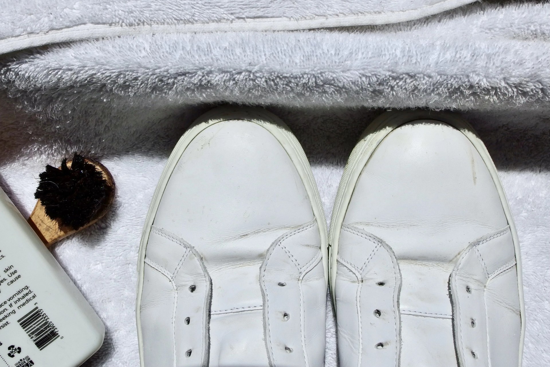white sneakers being cleaned