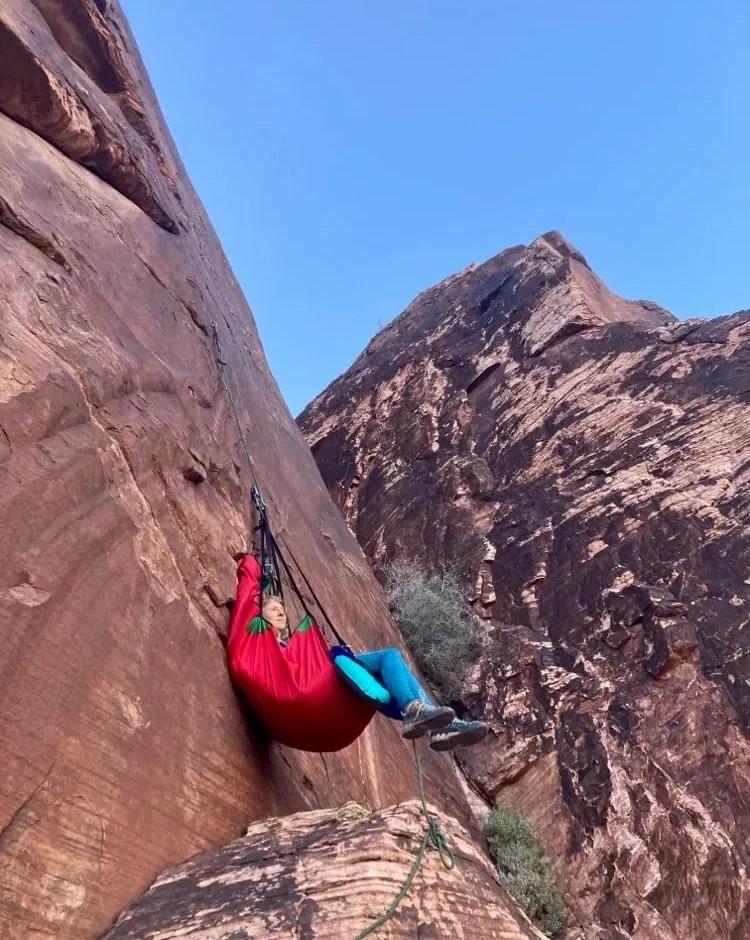 person hanging off of taco inflatable hammock world's lightest ledge system