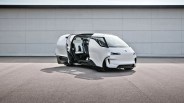 porsche minivan concept with sliding doors open parked in front of a large garage door