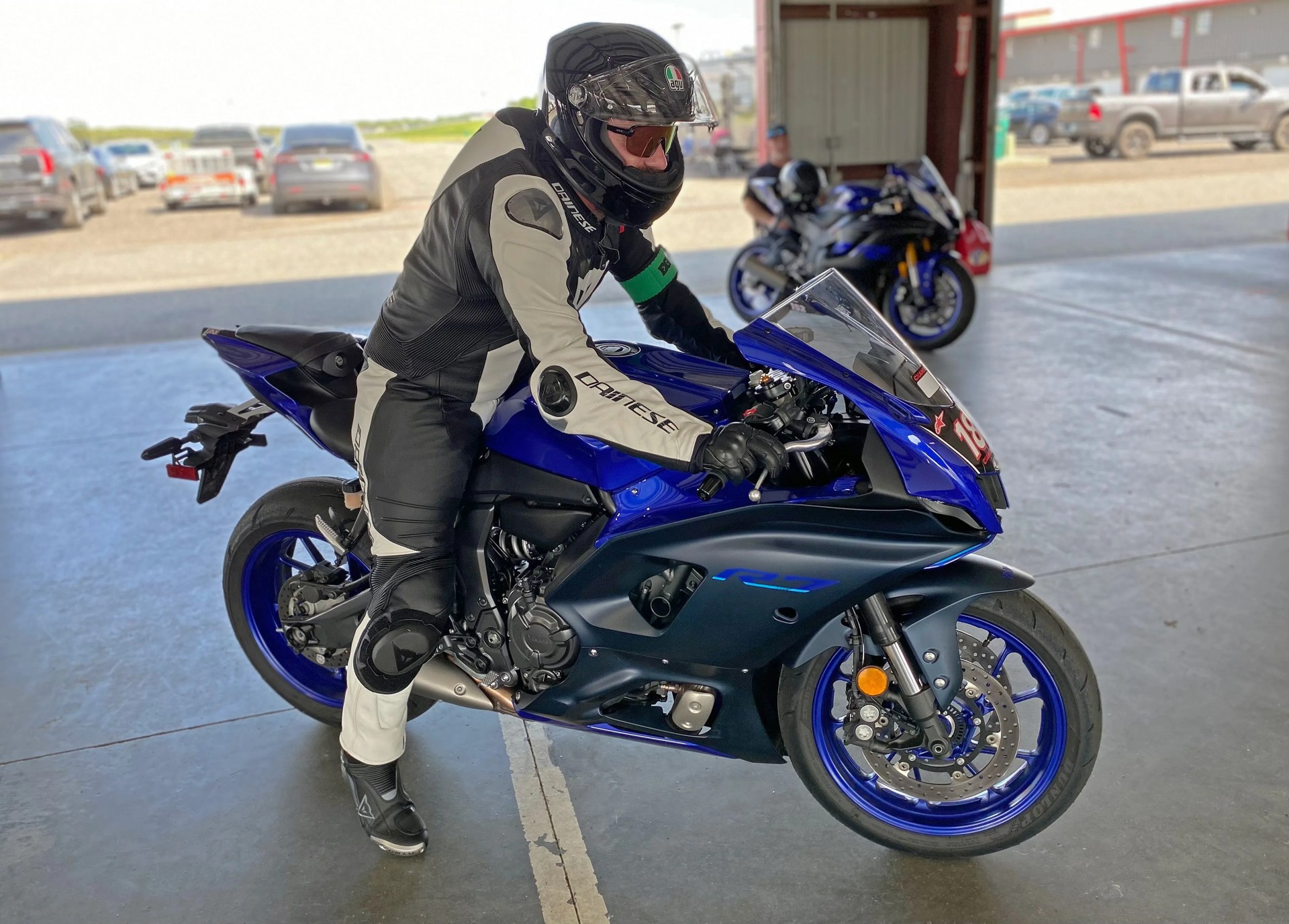 man sitting on a blue yamaha yzf motorcycle