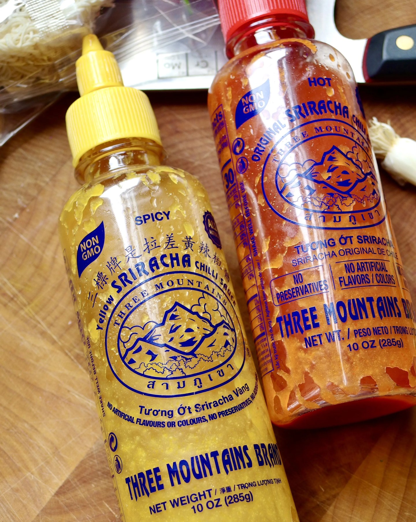 yellow sriracha next to red sriracha