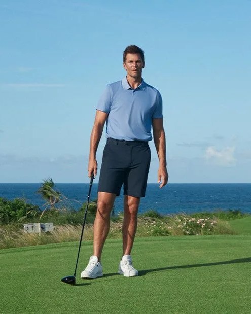 man wearing brady golf clothing collection holding golf club
