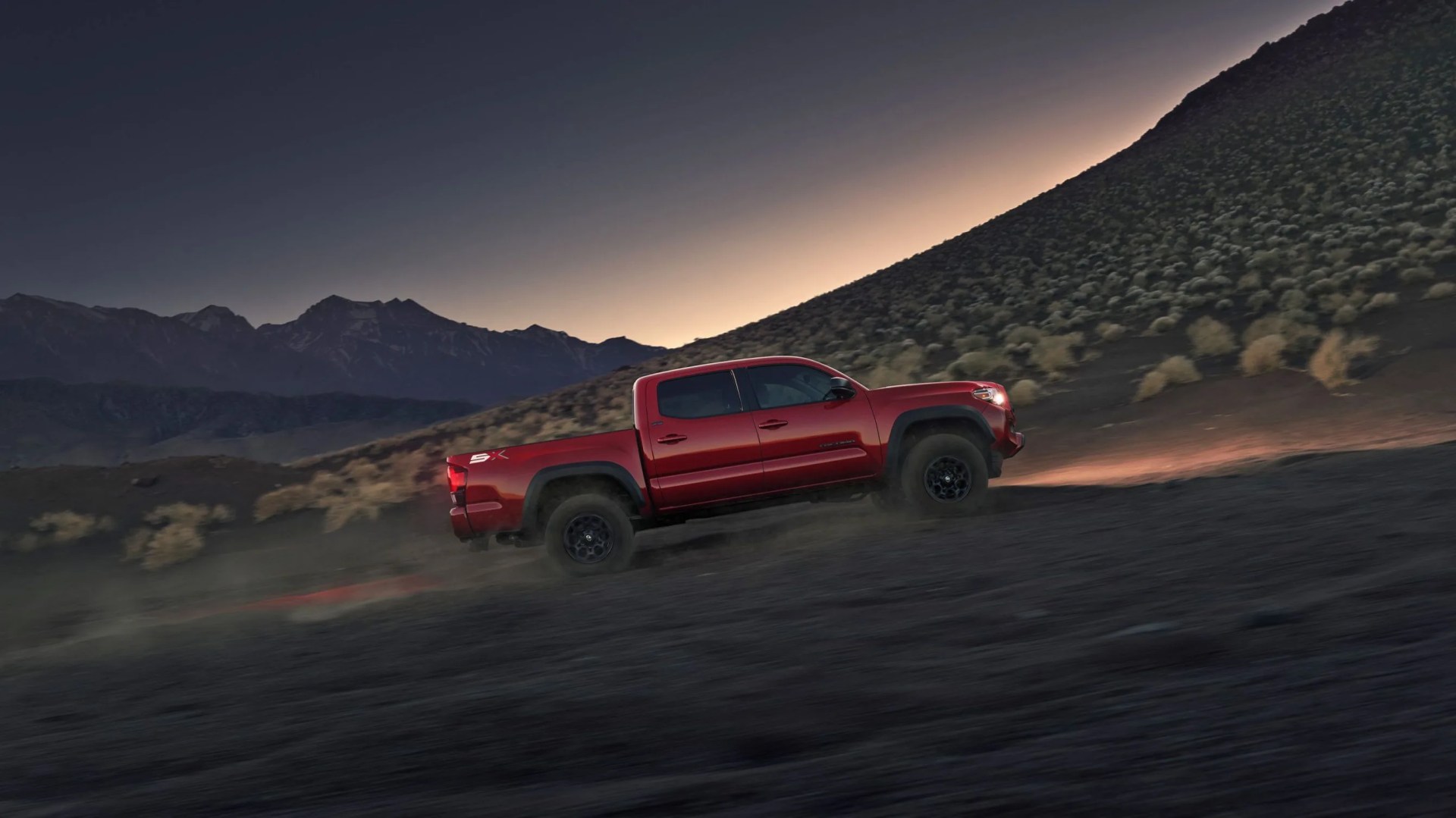 2023 toyota tacoma driving up hill in the desert