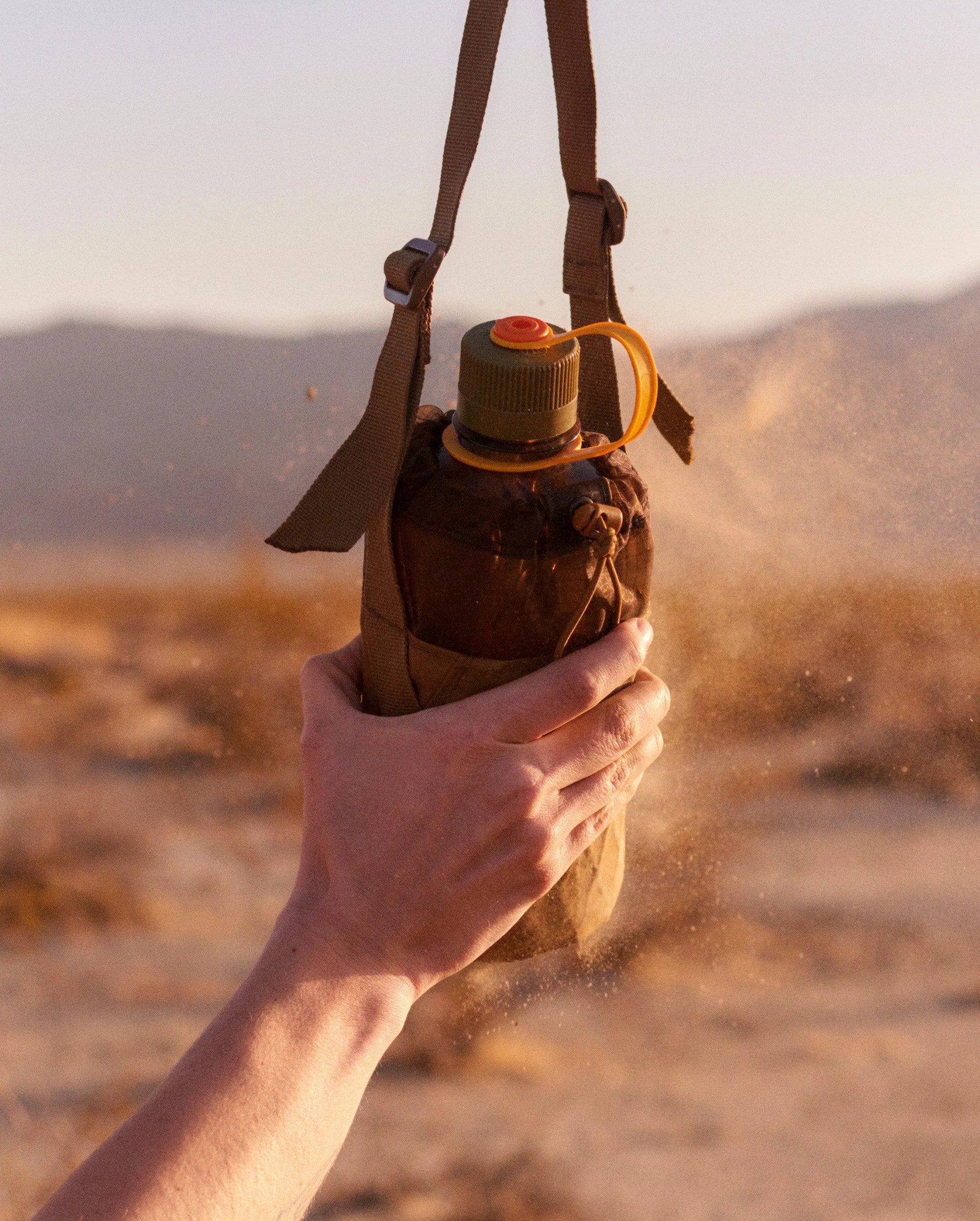 hikerkind x allmansright bottle bag held in hand