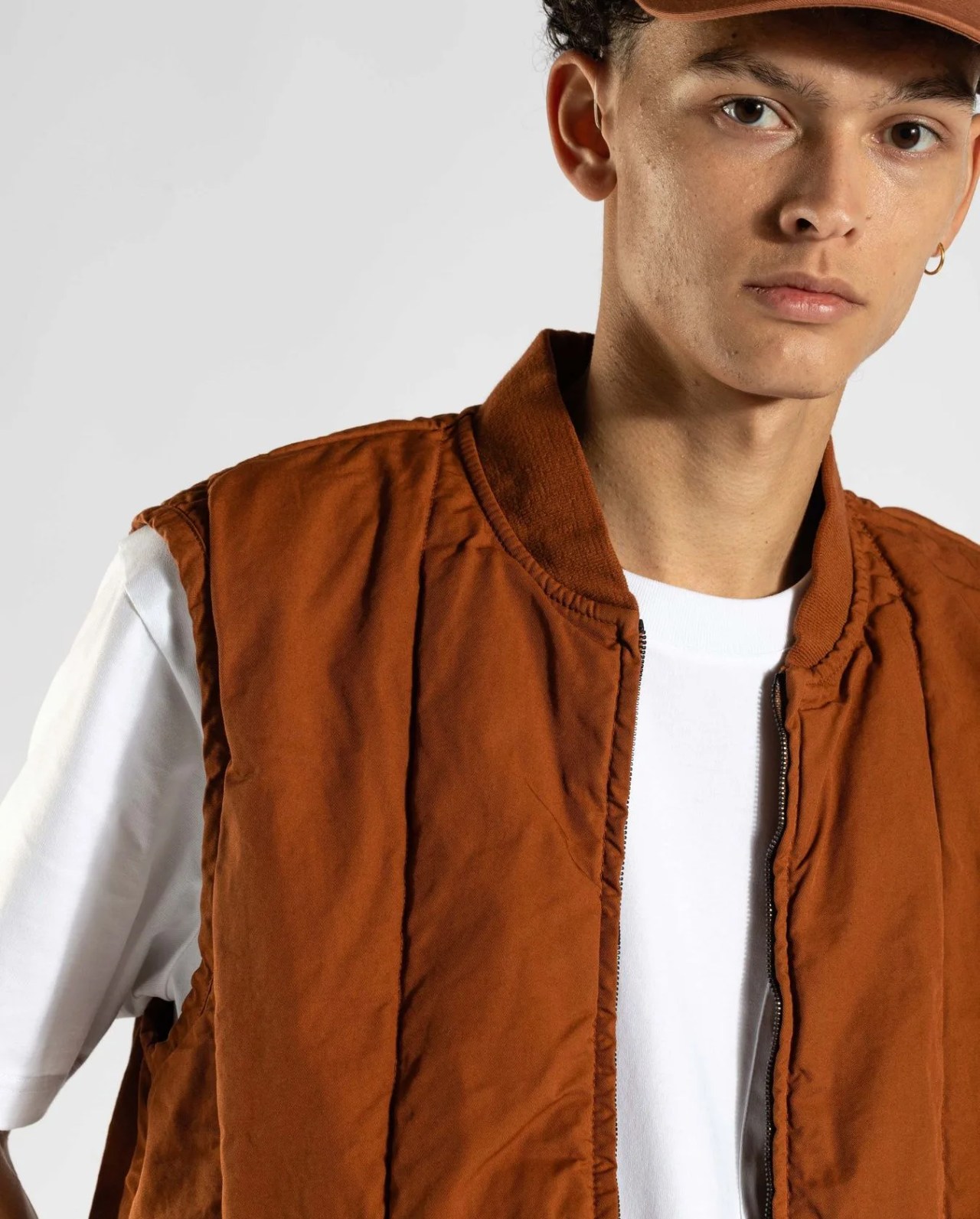 man wearing norse projects gm x np peter twill vest