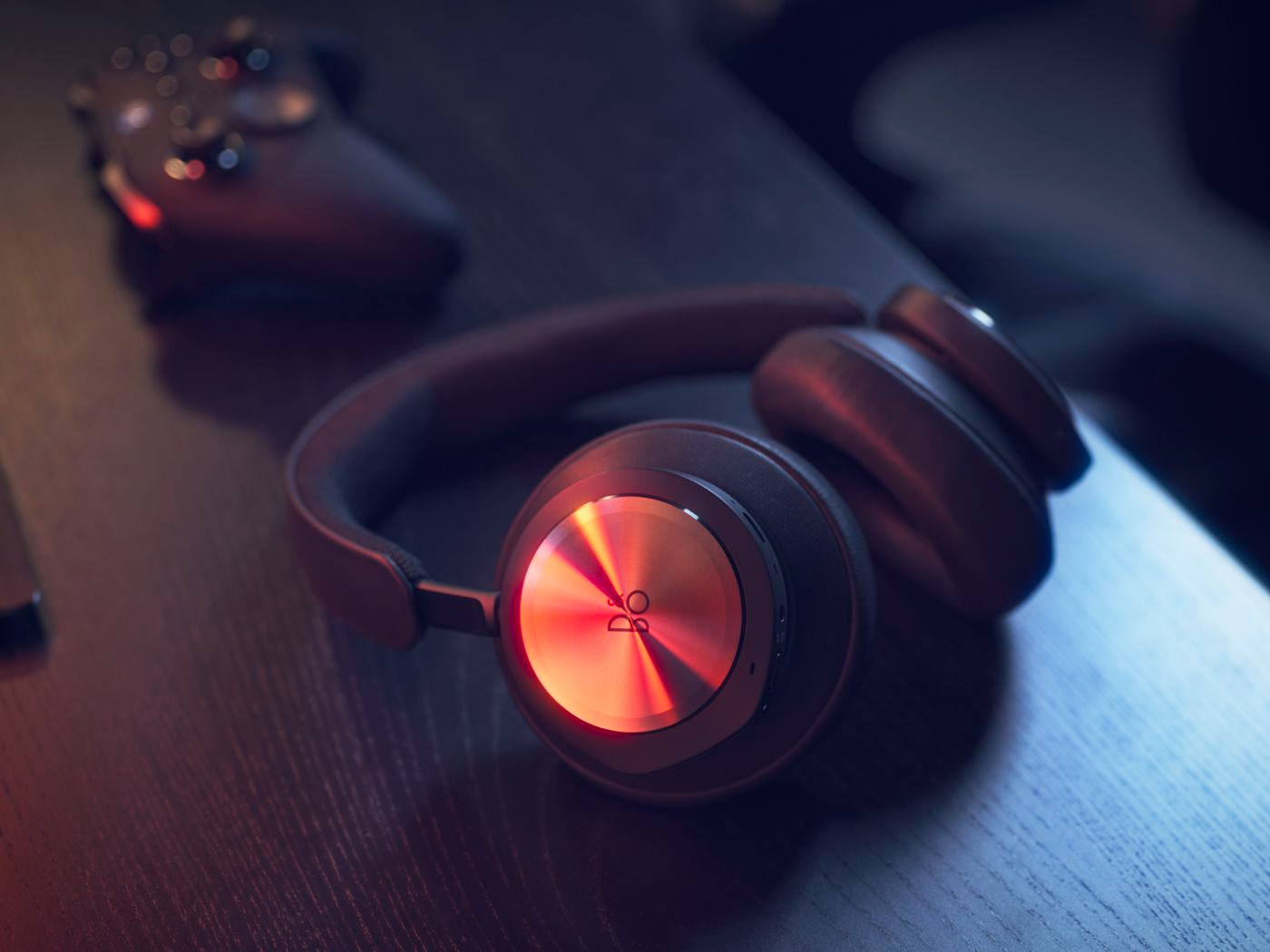 bang  olufsen beoplay portal gaming headphones on desk with xbox controller