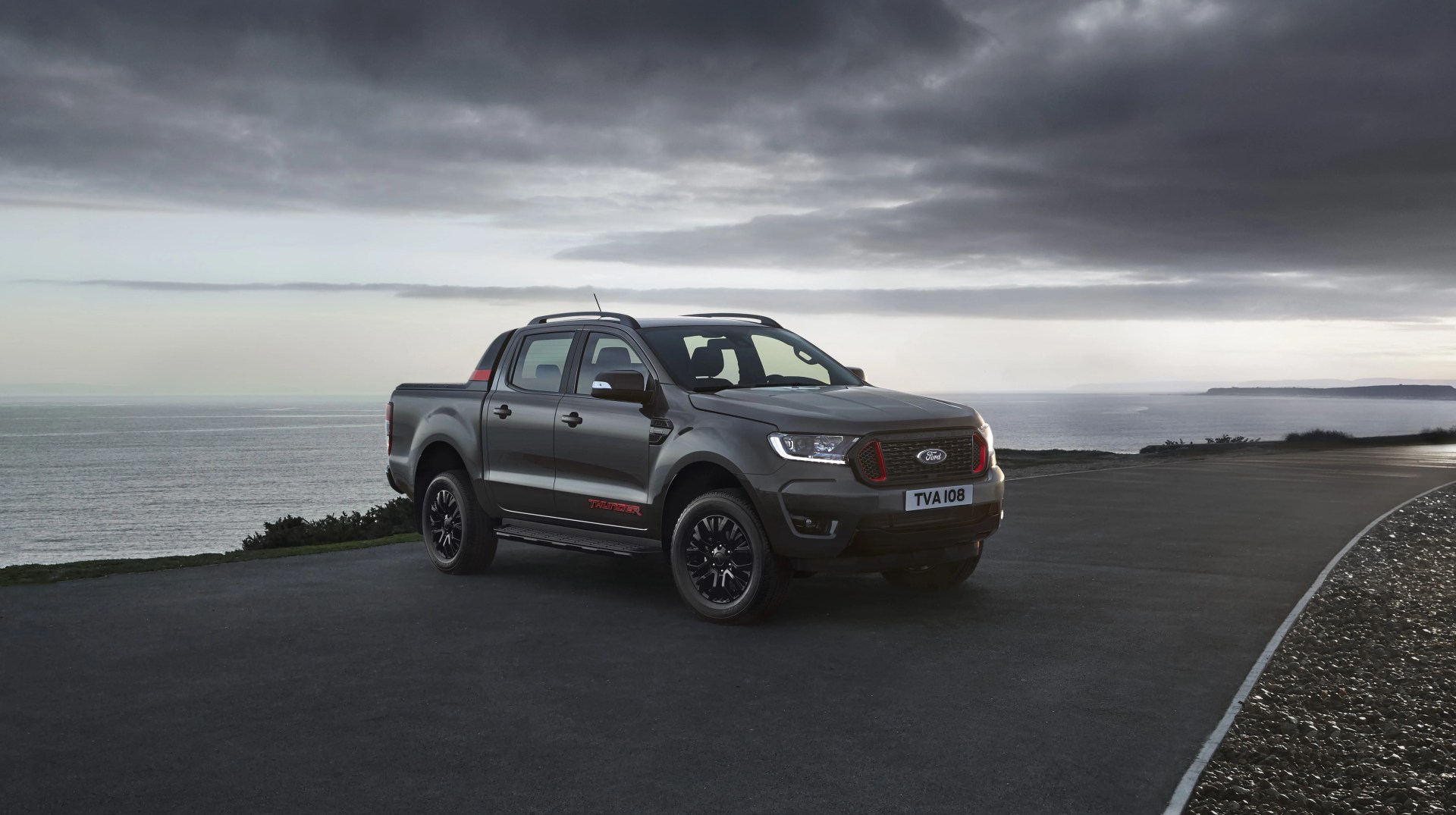 ford ranger thunder parked in front of an ocean with storm clouds rolling in