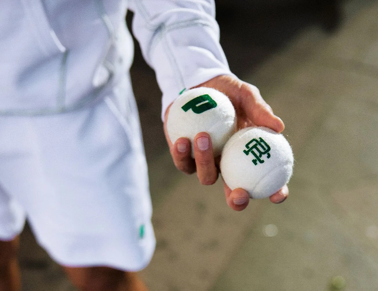 someone holding tennis balls