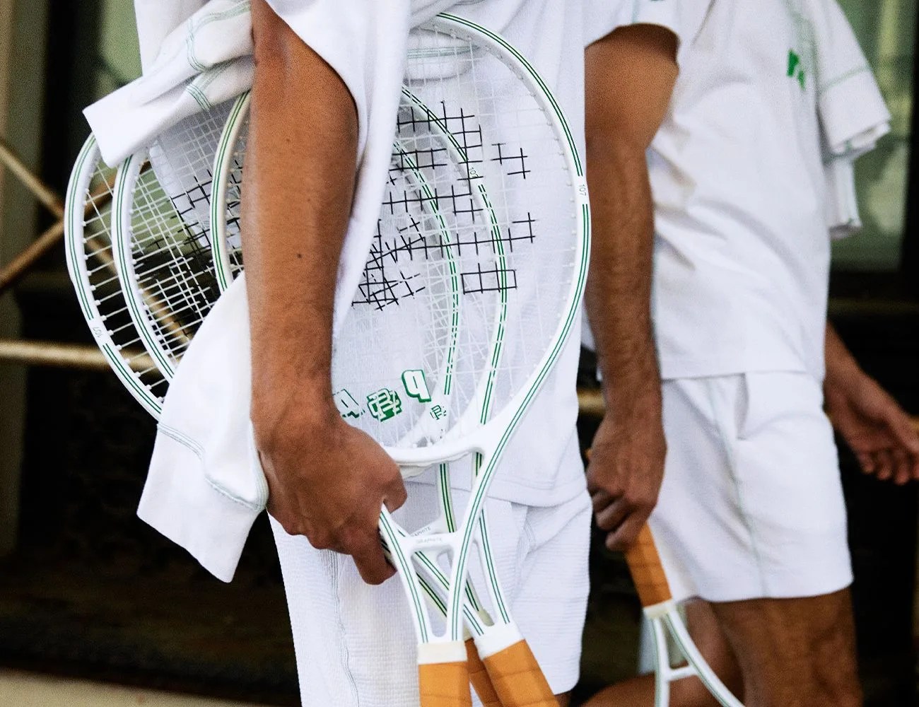 someone holding tennis rackets
