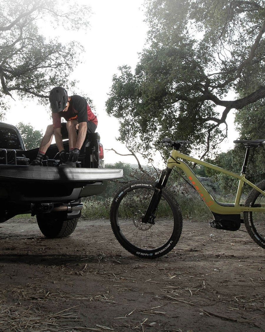 man sitting on back of car getting ready to ride serial 1 e bike